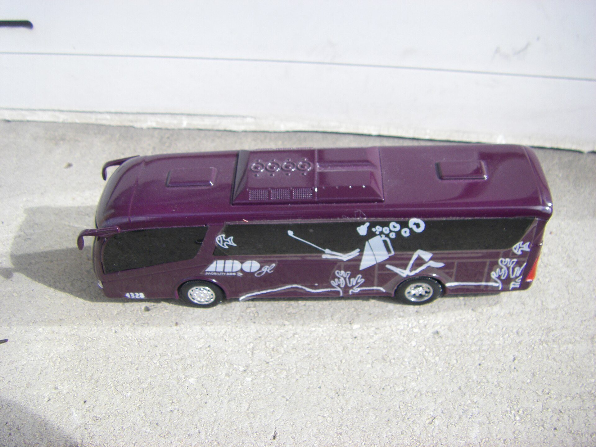 Model of a long-distance Mexican ADO bus in purple