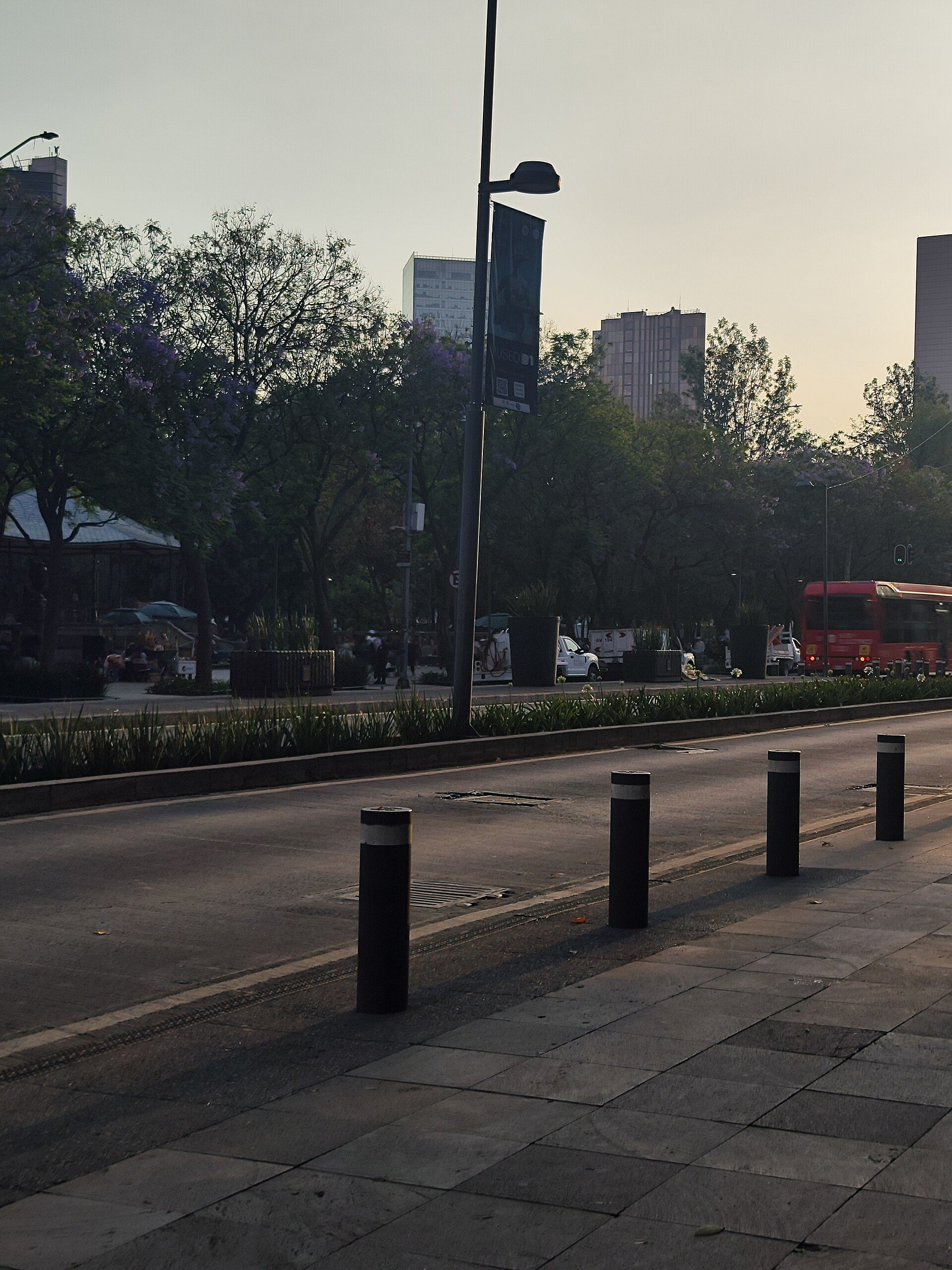 Cityscape view from a modern room with large windows and a balcony.