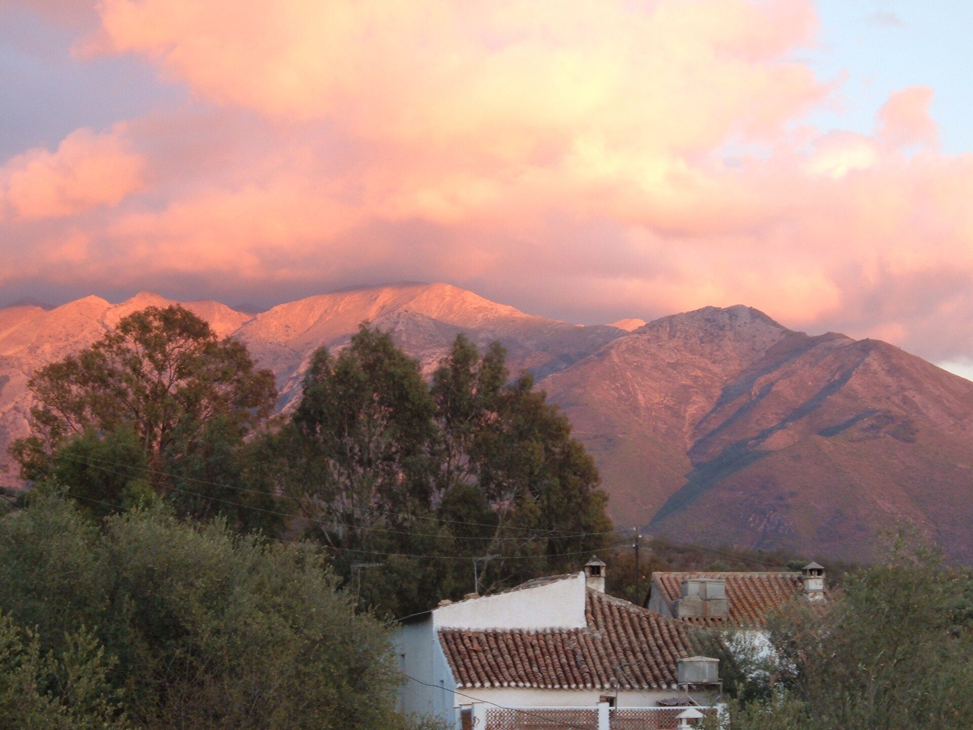 Cozy room with mountain view, large windows, and wooden furniture.