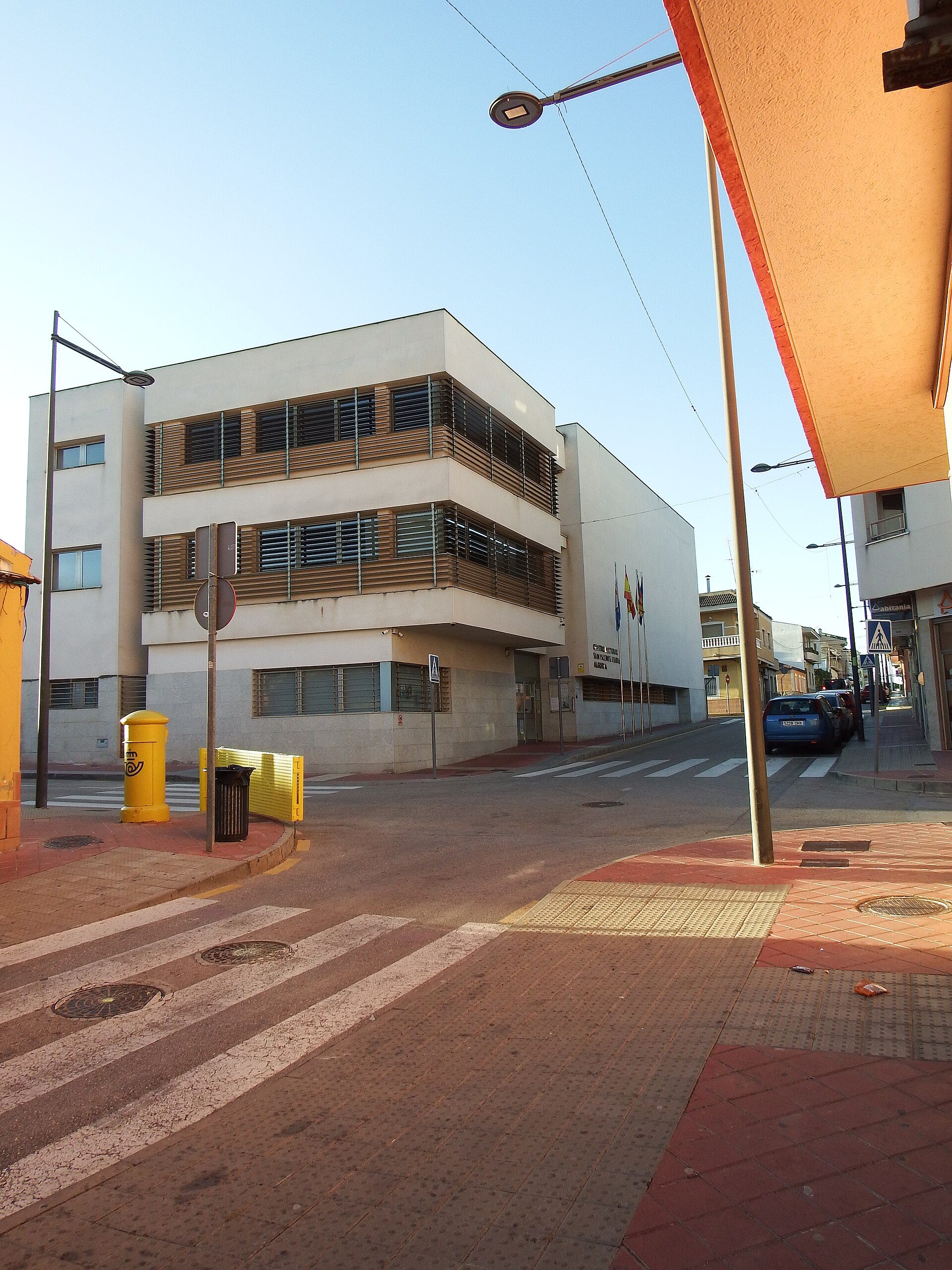 Modern apartment with city view, balcony, and large windows.