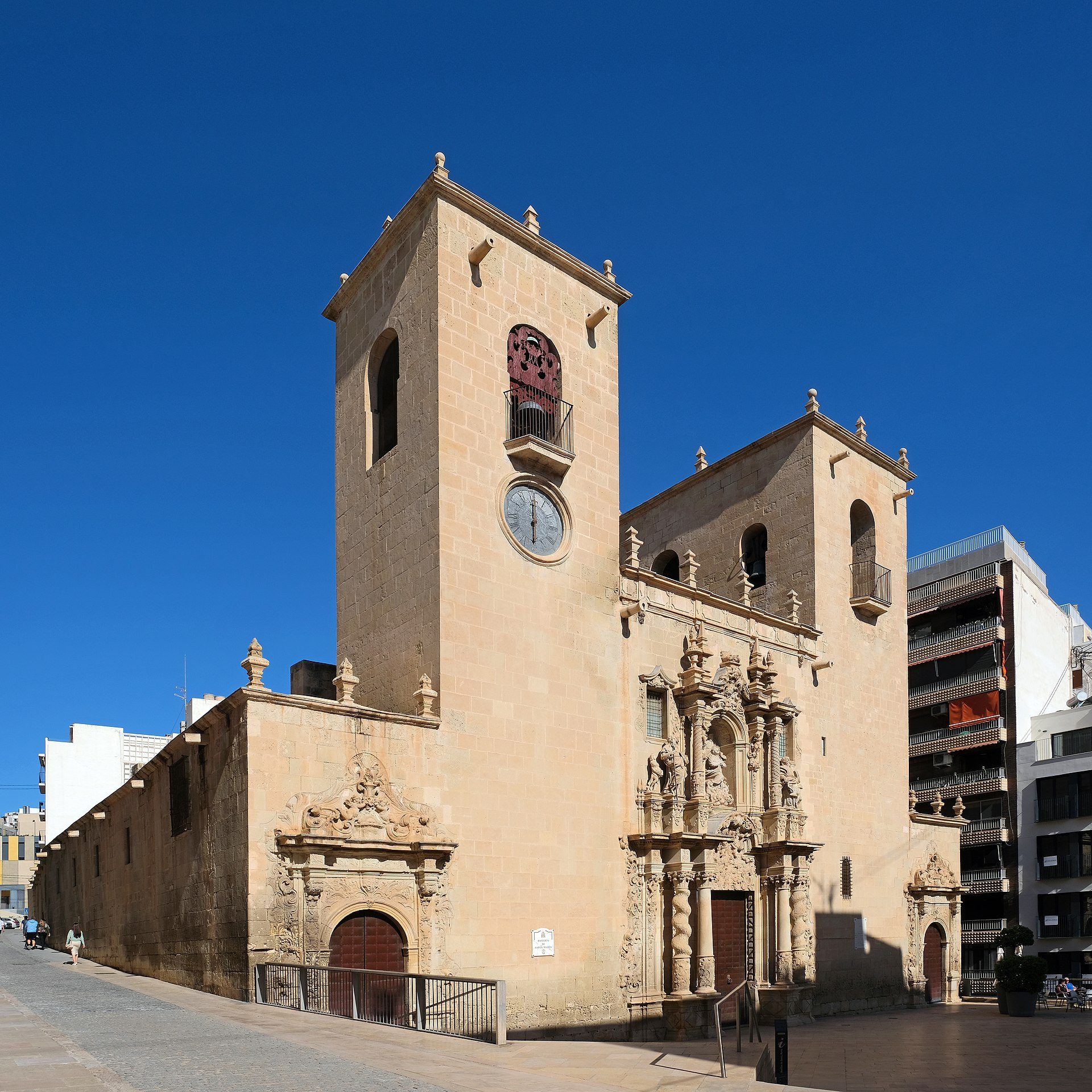 Alt text: Historic church with clock tower, ornate facade, and clear blue sky.