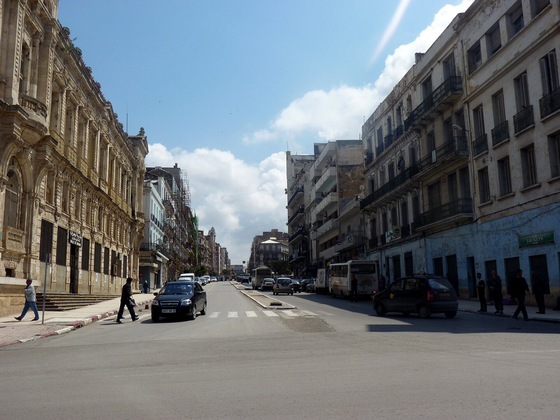 Alt text: Spacious room with city view, featuring large windows and modern decor.