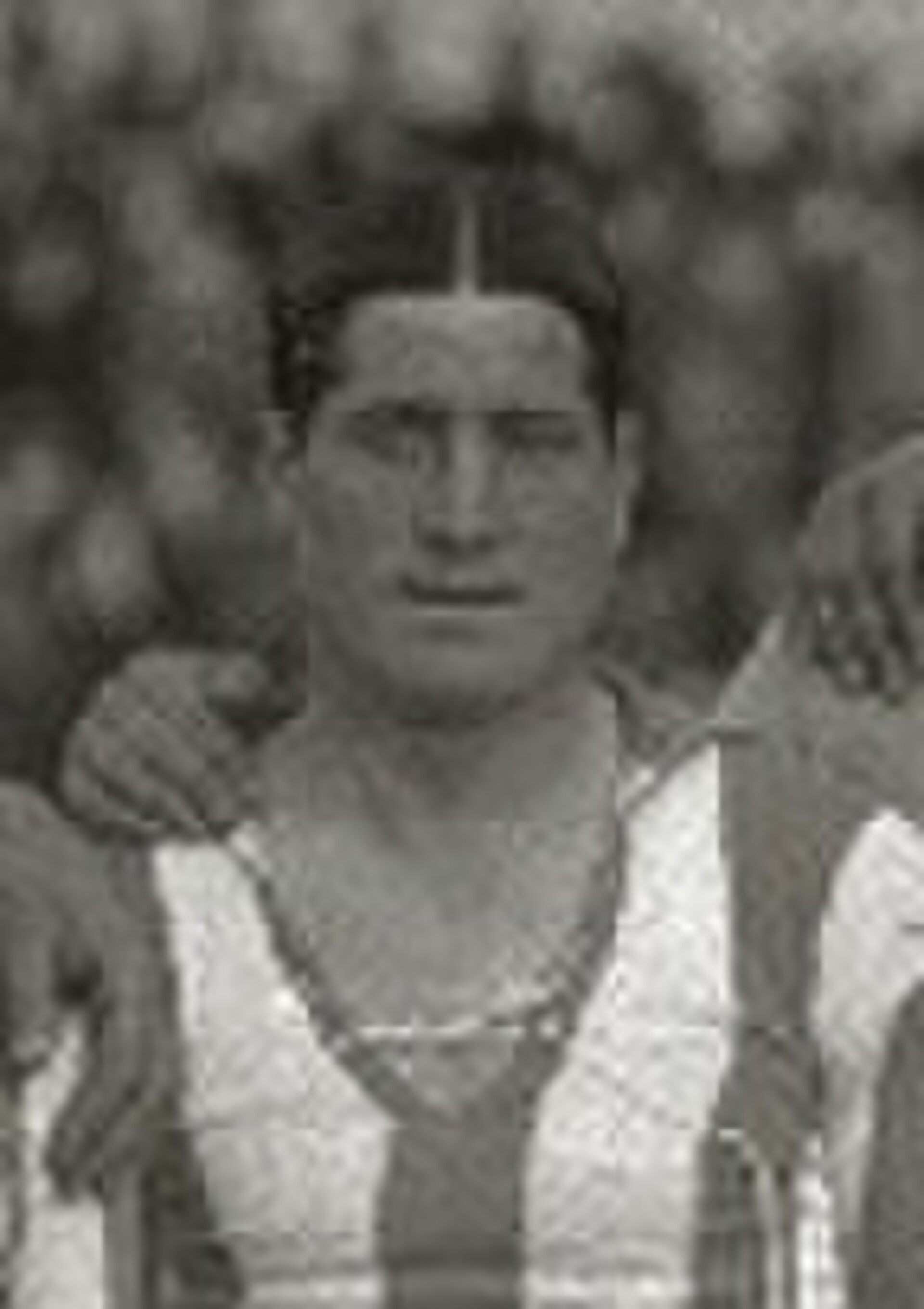 Alt text: Vintage black and white photo of a person in a striped outfit.