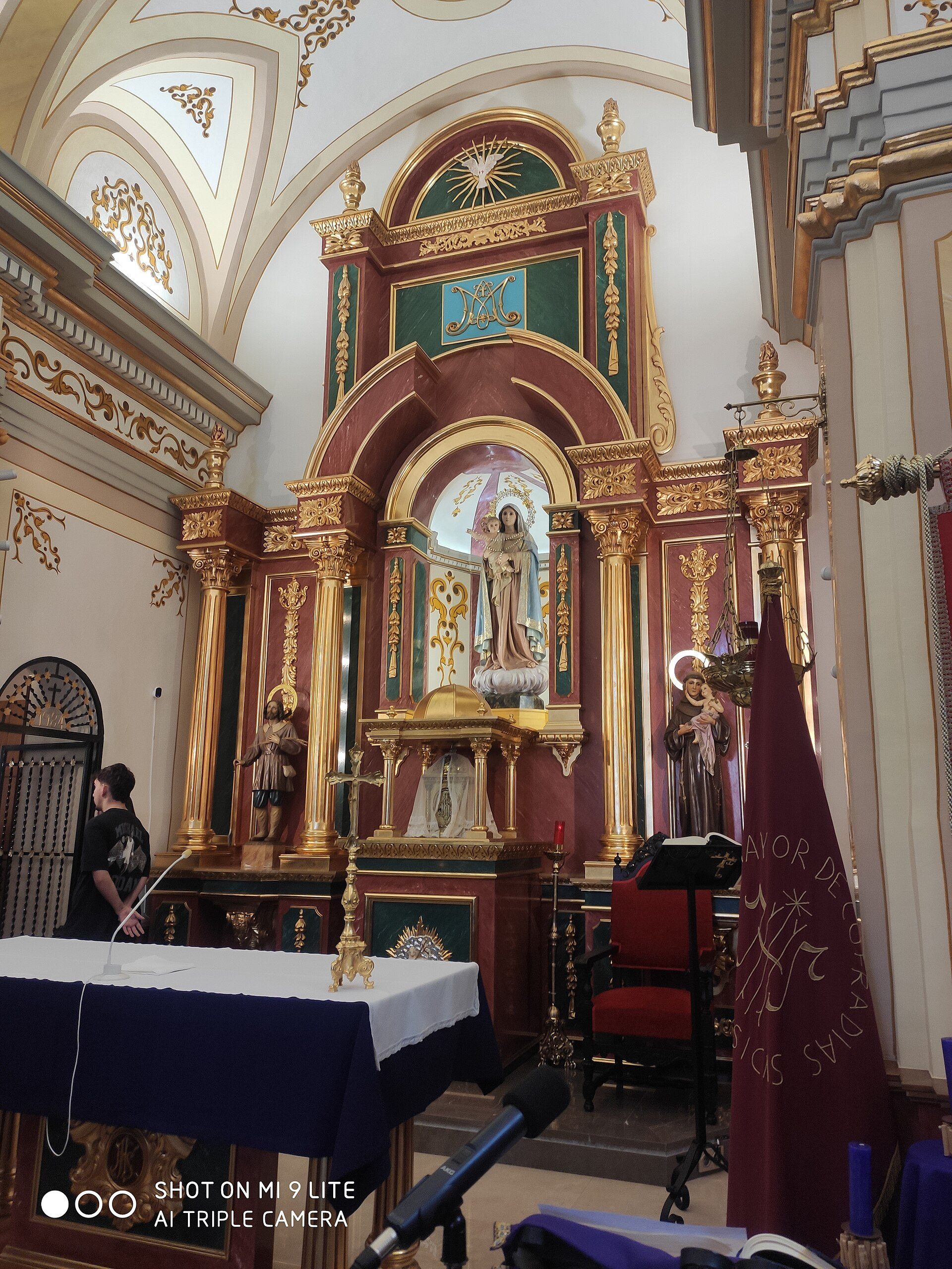 Alt text: Interior of a church with ornate decorations, altar, and religious statues.