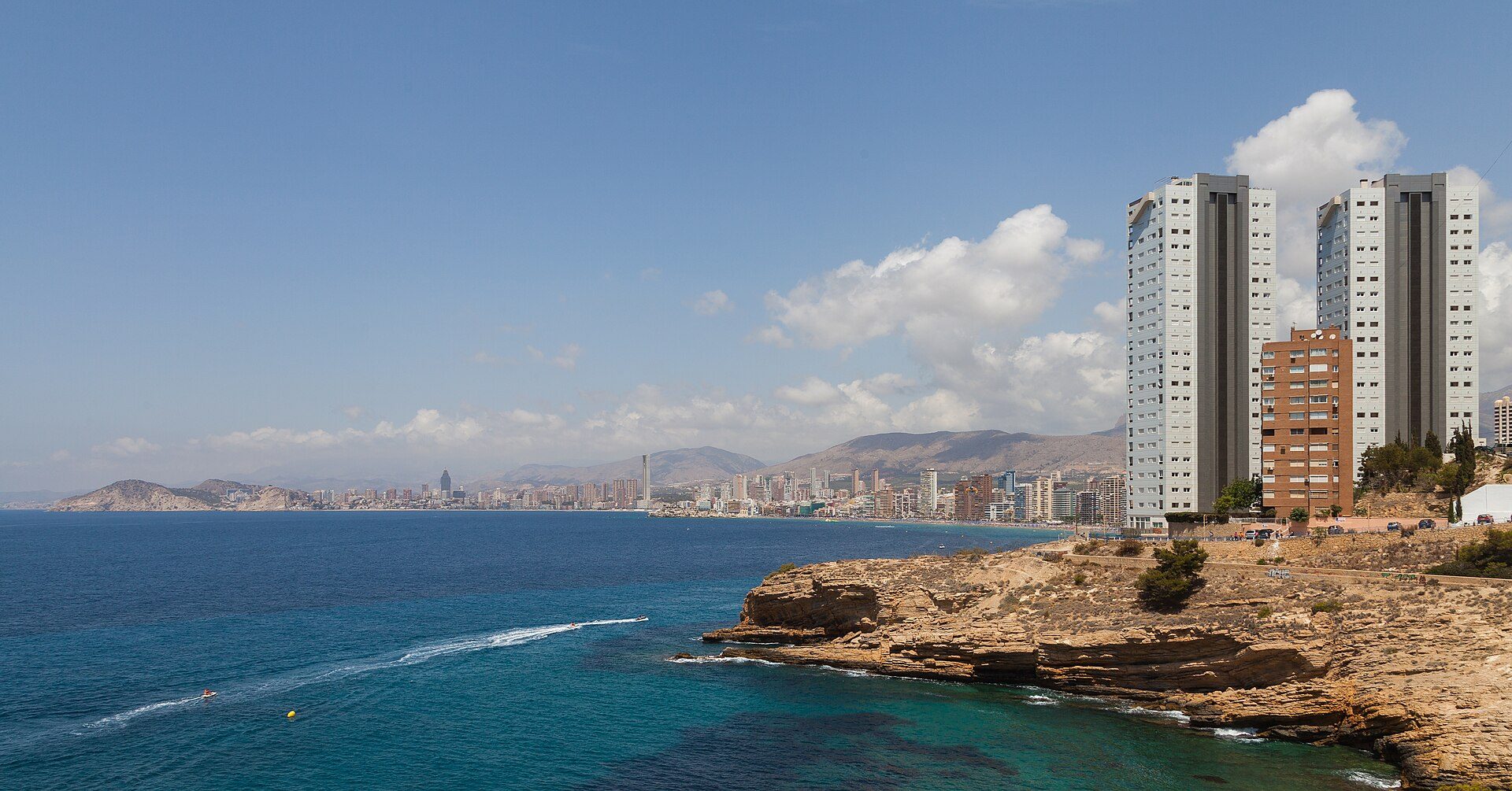 Oceanfront apartment with balcony, city and sea views, modern amenities.