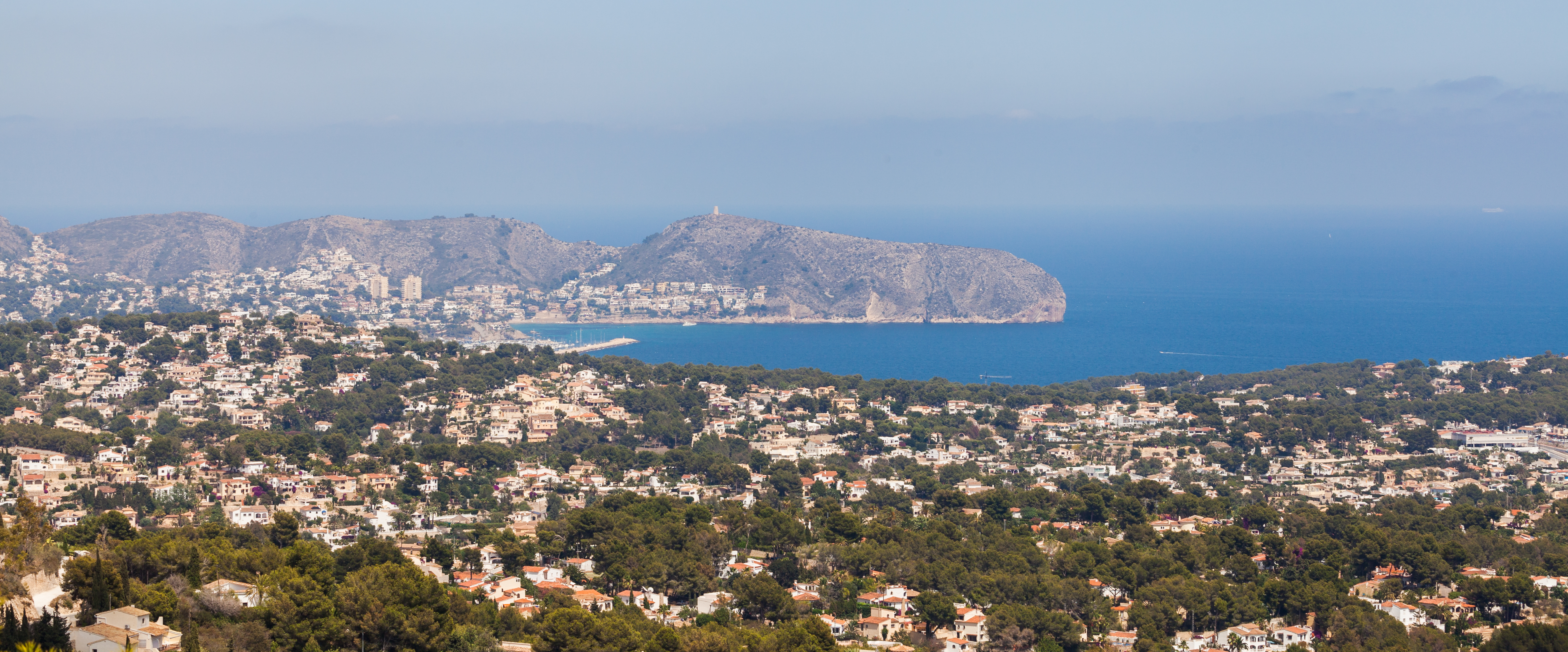 Aerial view of Calpe, Spain, showcasing the coastline and surrounding properties.
