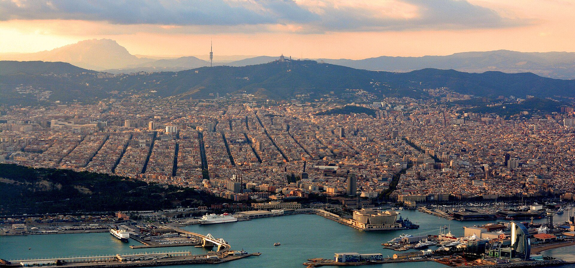 With part of the Port of Barcelona in the foreground and Montserrat Mountain at