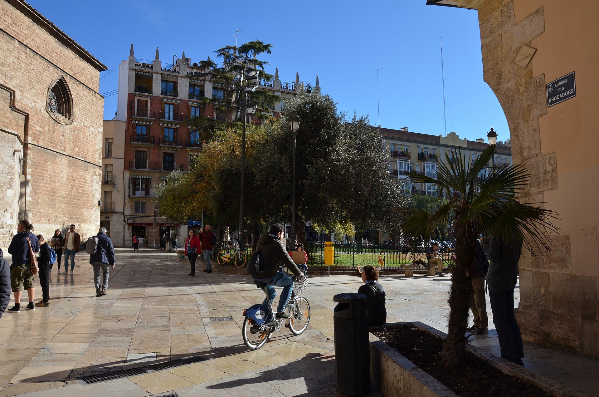 Alt text: Spacious room with city view, featuring large windows, modern decor, and comfortable seating.