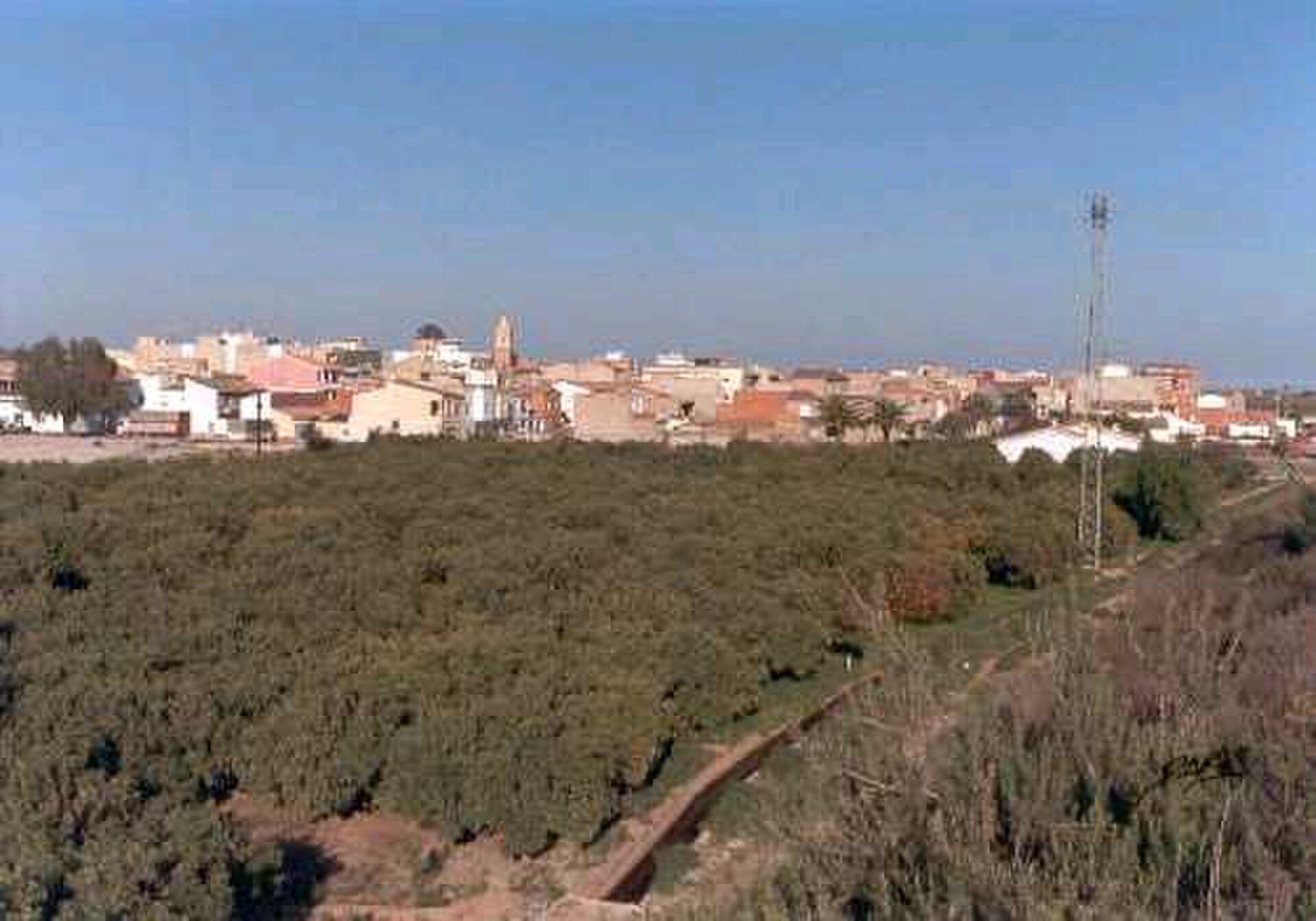 Alt text: Bedroom with garden view, featuring large windows and a balcony.