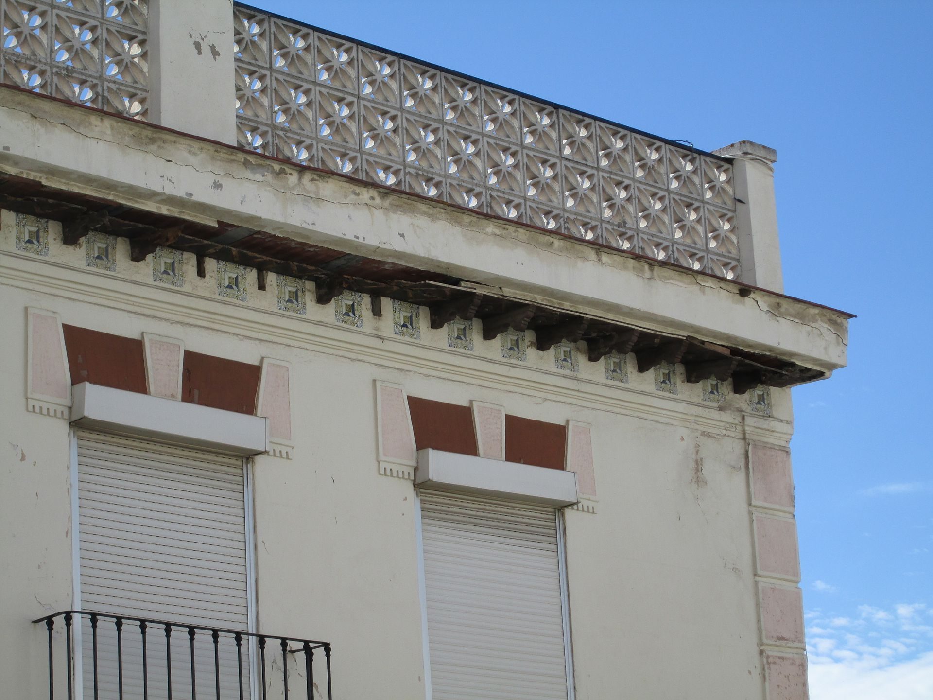 Alt text: Upper floor apartment with balcony, city view, decorative railing.