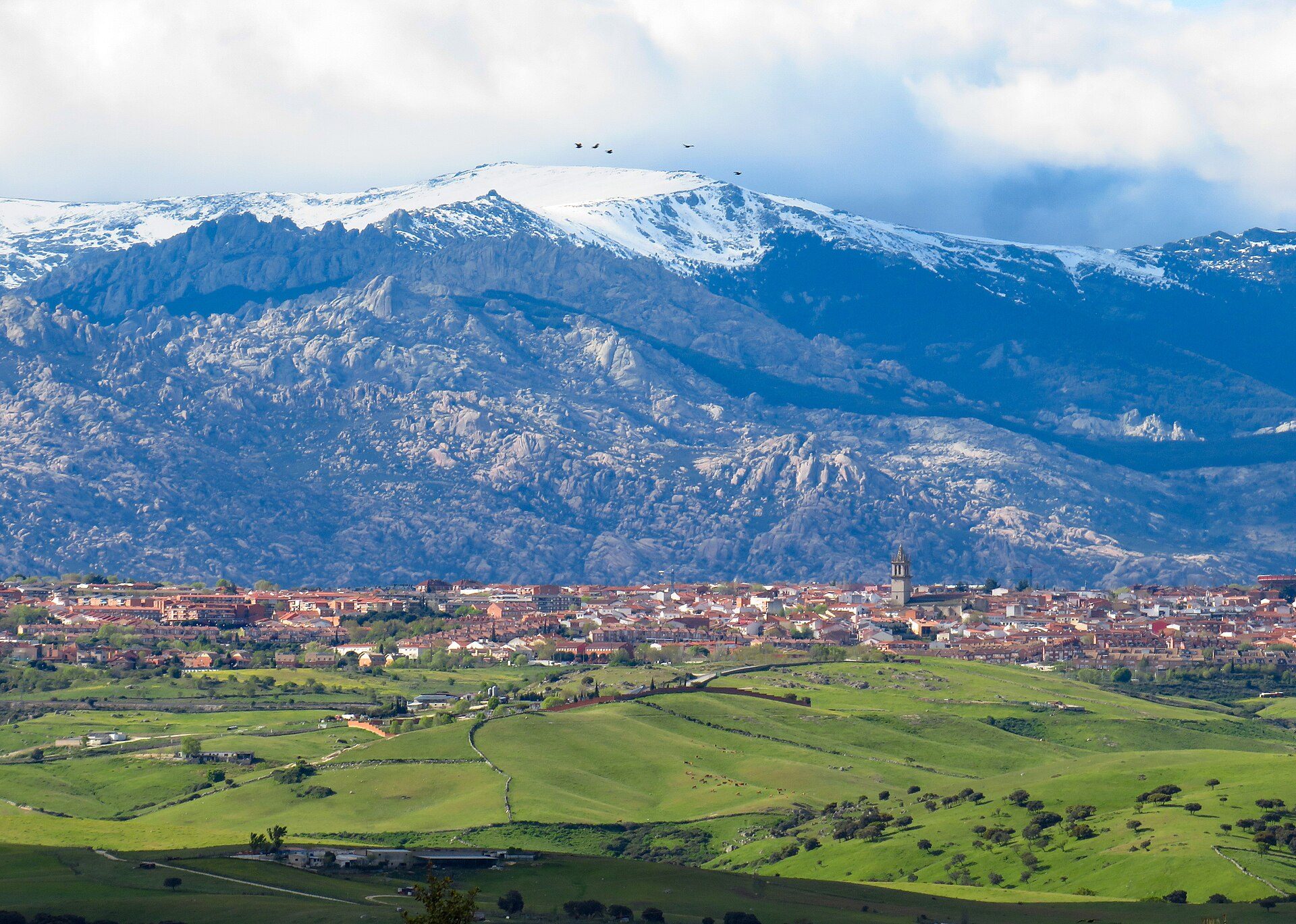 Alt text: Room with mountain view, featuring large windows and a balcony.