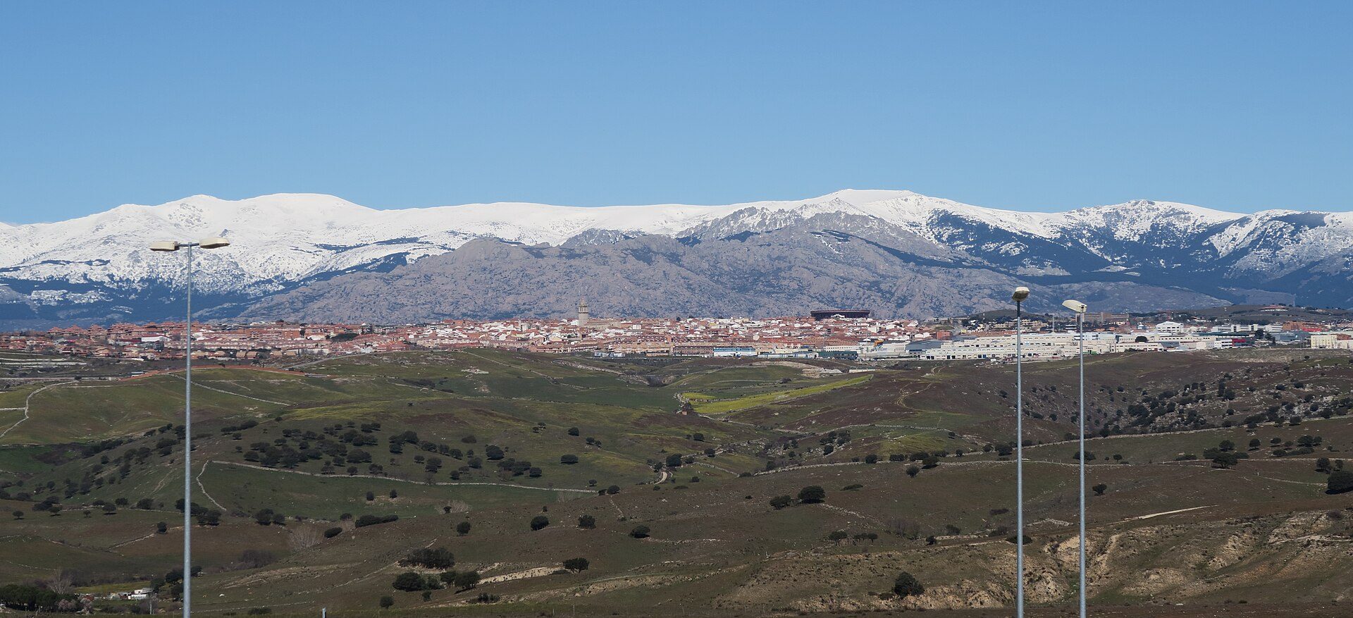 Alt text: Room with mountain view, large windows, balcony, and modern decor.