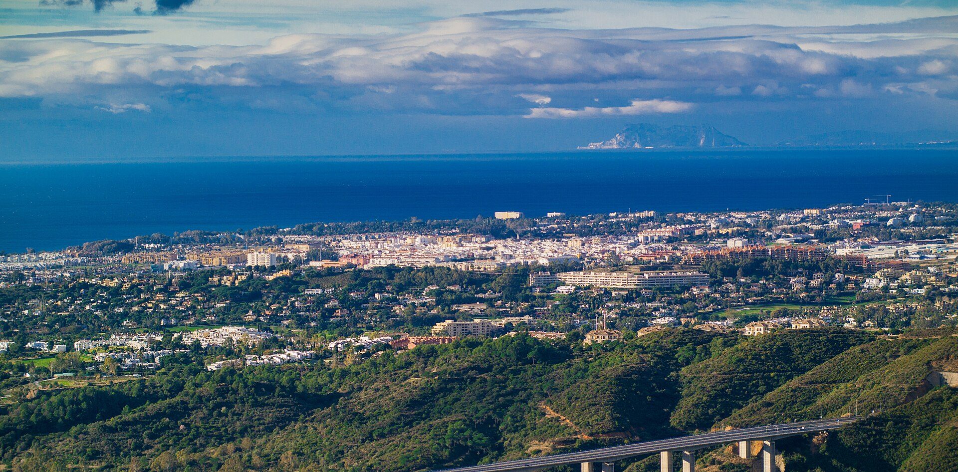 Oceanfront room with balcony, city and mountain views, modern amenities.