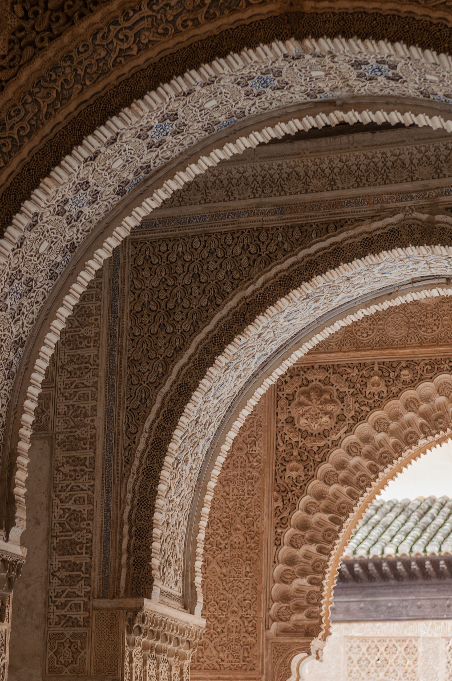 Intricate arches and detailed tile work in a traditional Moroccan room.