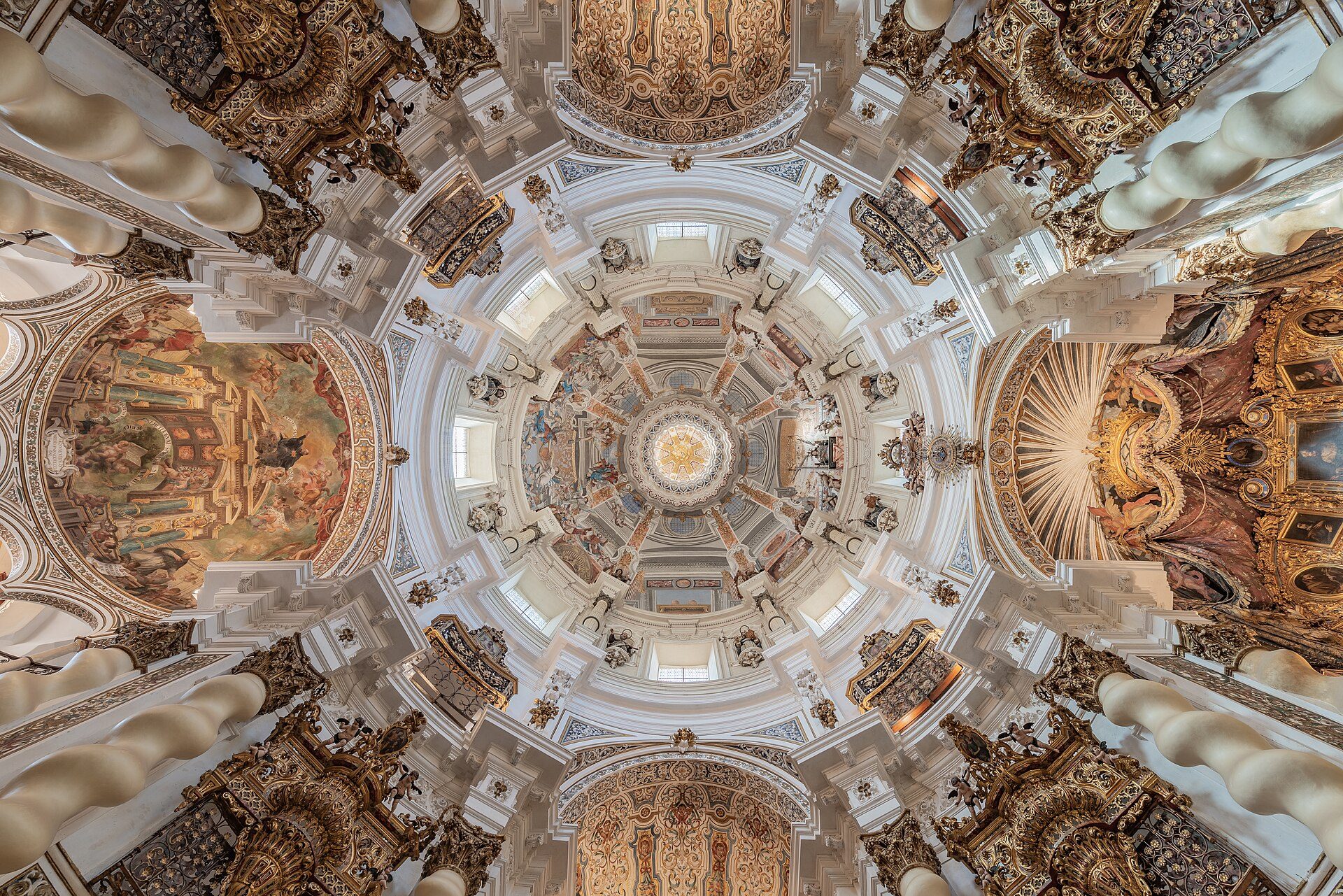 Intricate ceiling frescoes and ornate architectural details in a grand, domed room.