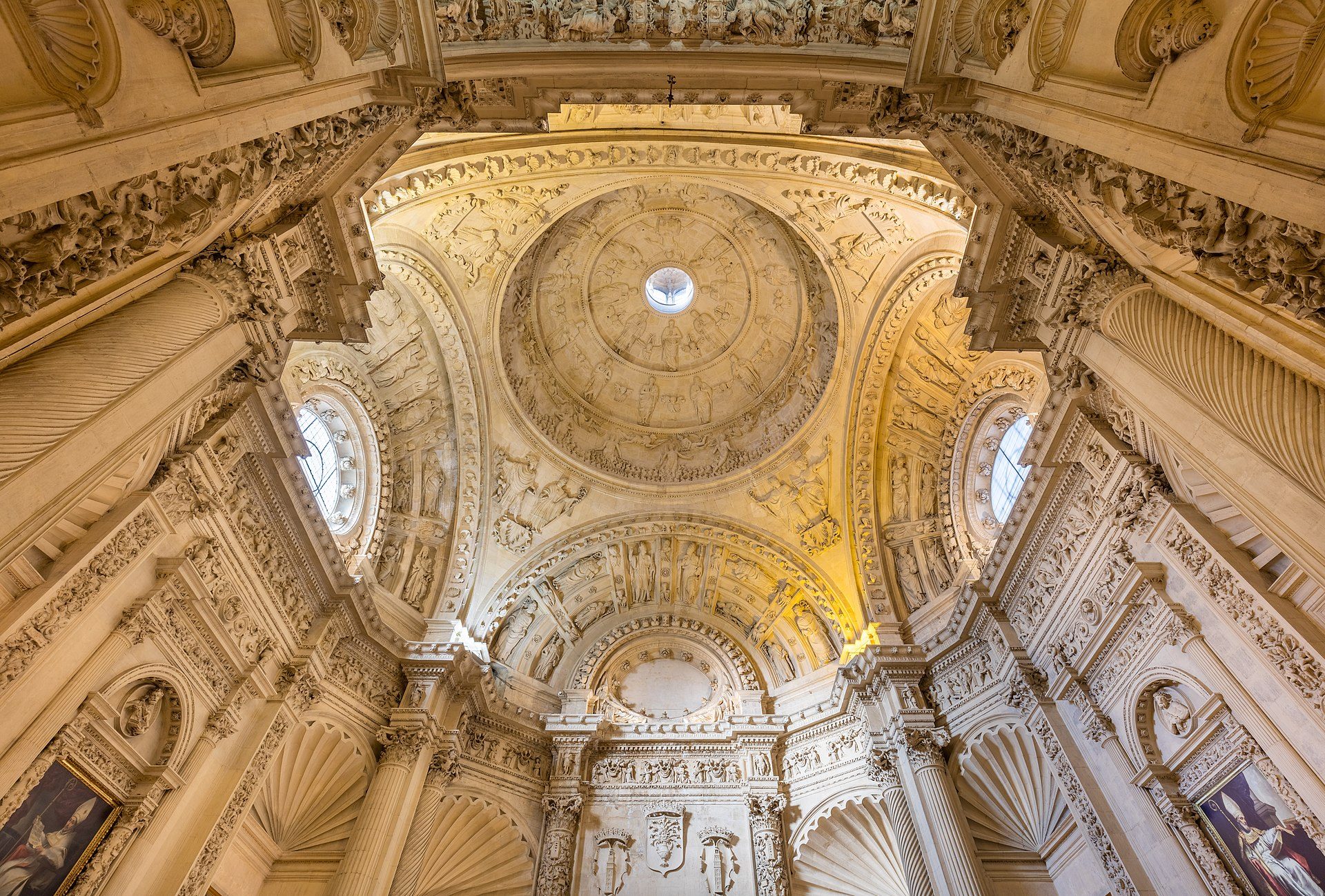 Intricate ceiling and columns in a grand, ornate room with a large dome.