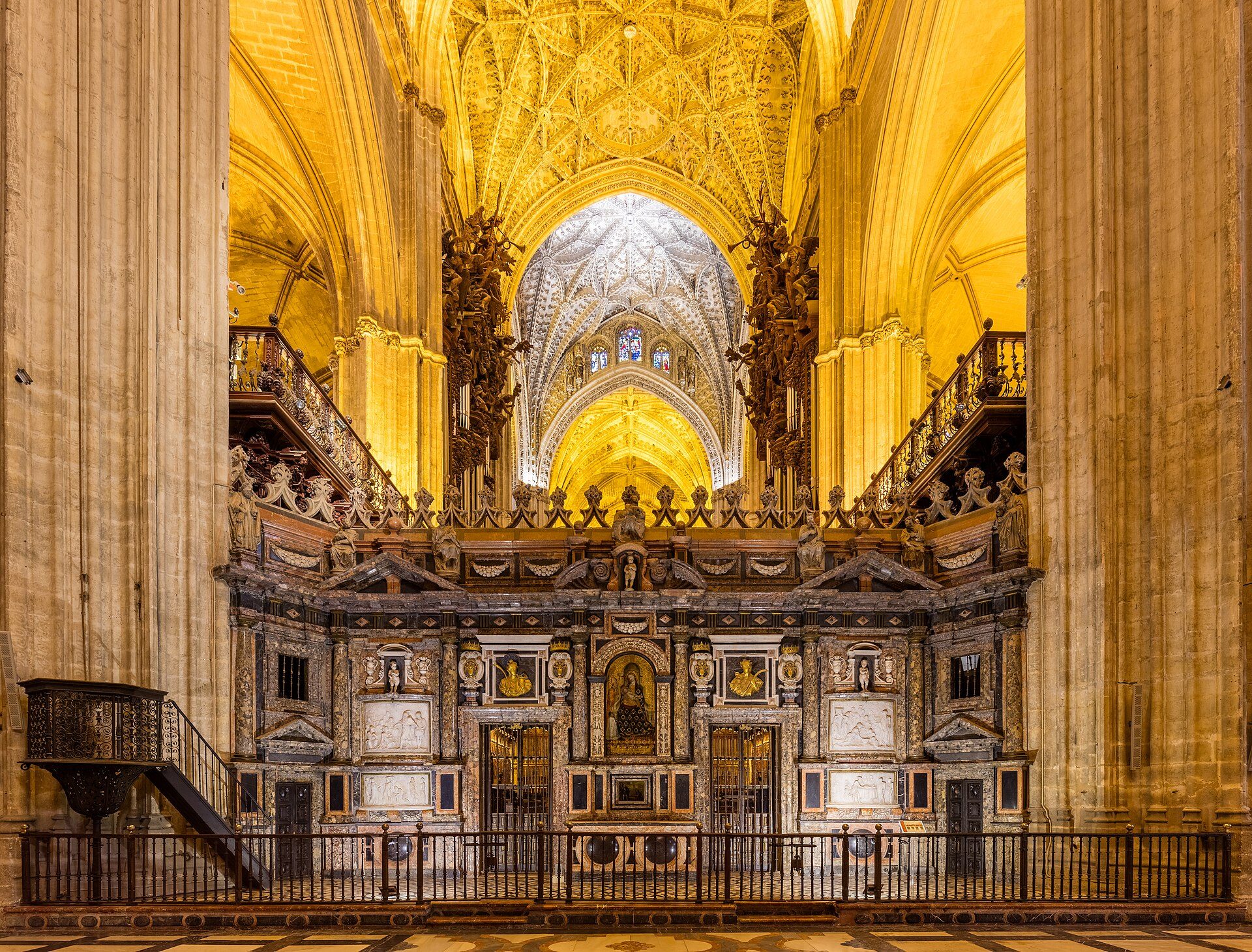 Interior view of a grand cathedral with ornate decorations and high vaulted ceilings.