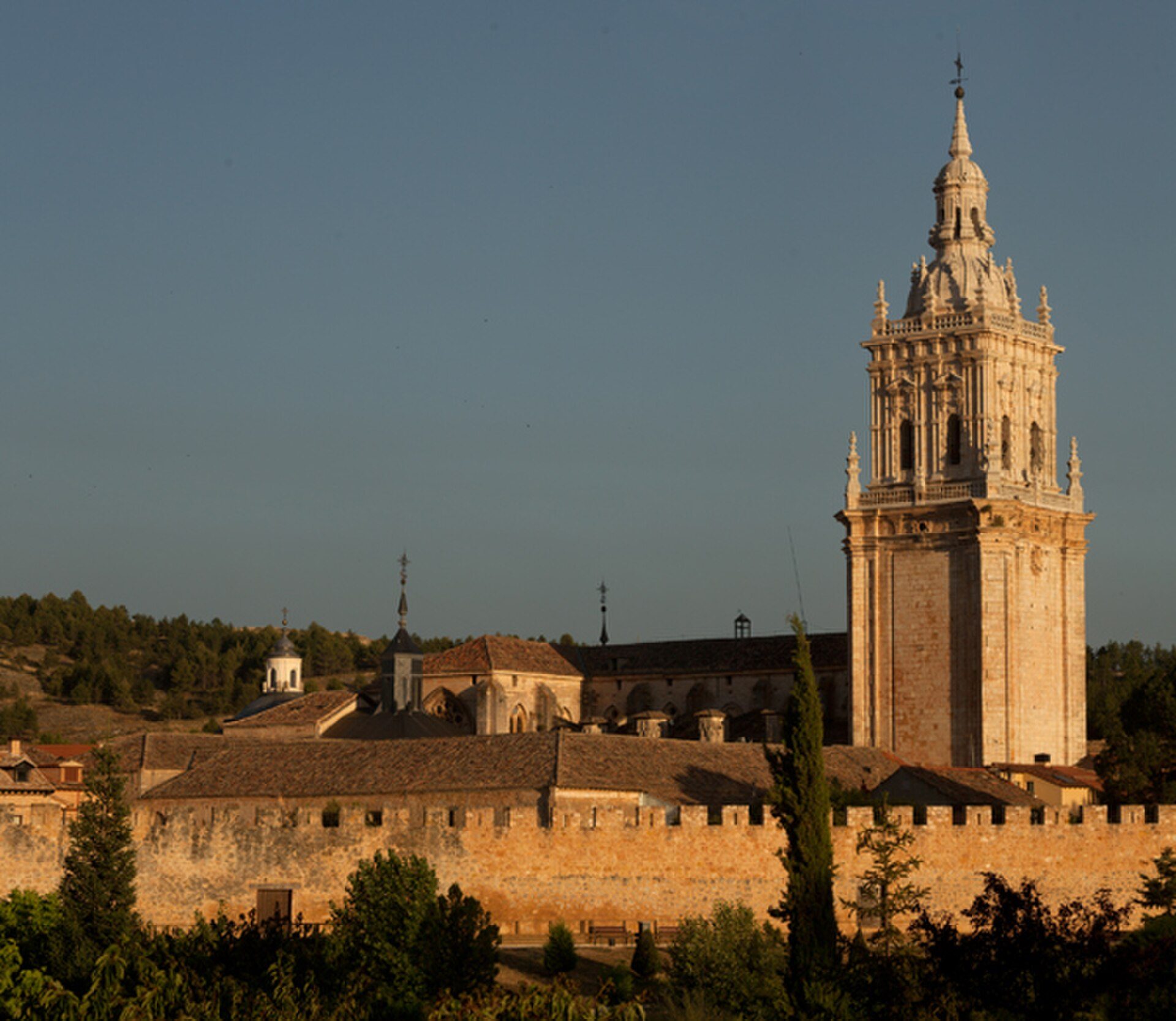 Alt text: Historic building with a tall bell tower and scenic view of surrounding landscape.