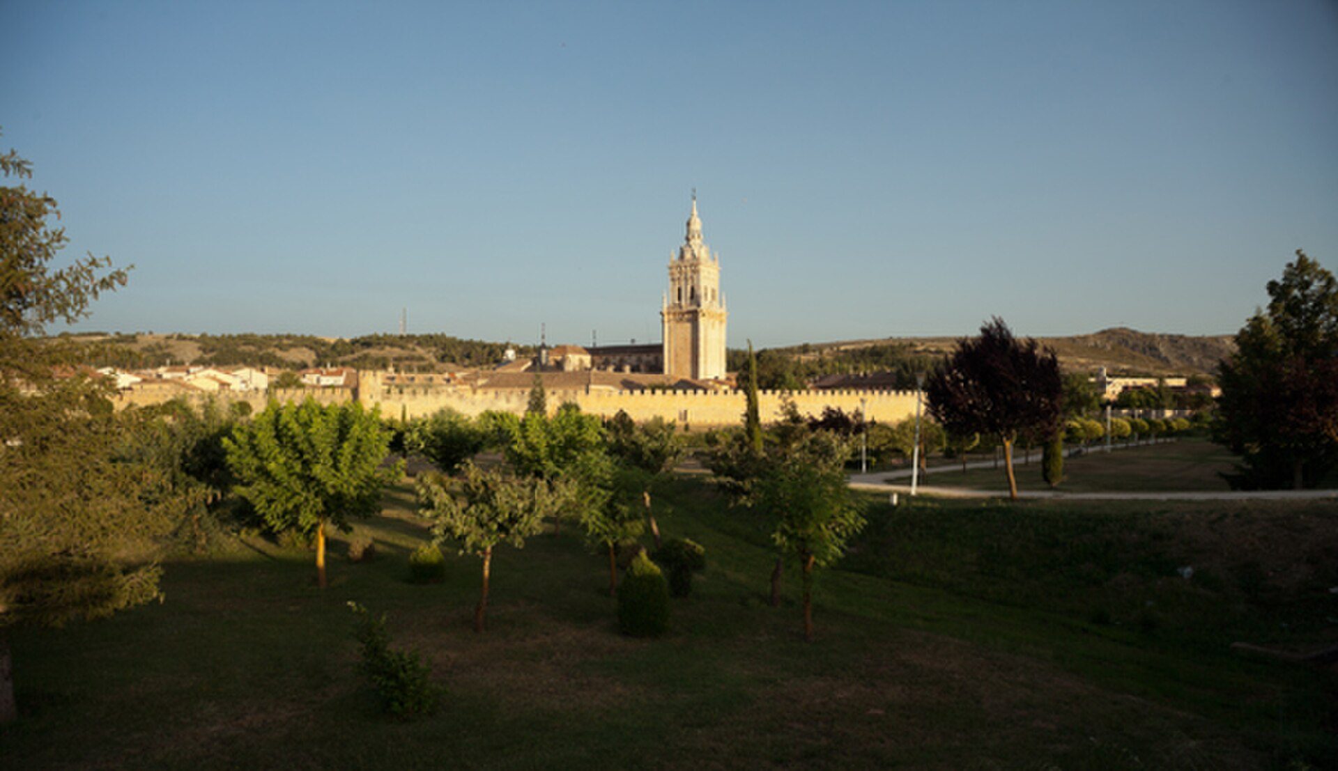 Spacious room with cityscape view, featuring large windows and modern decor.