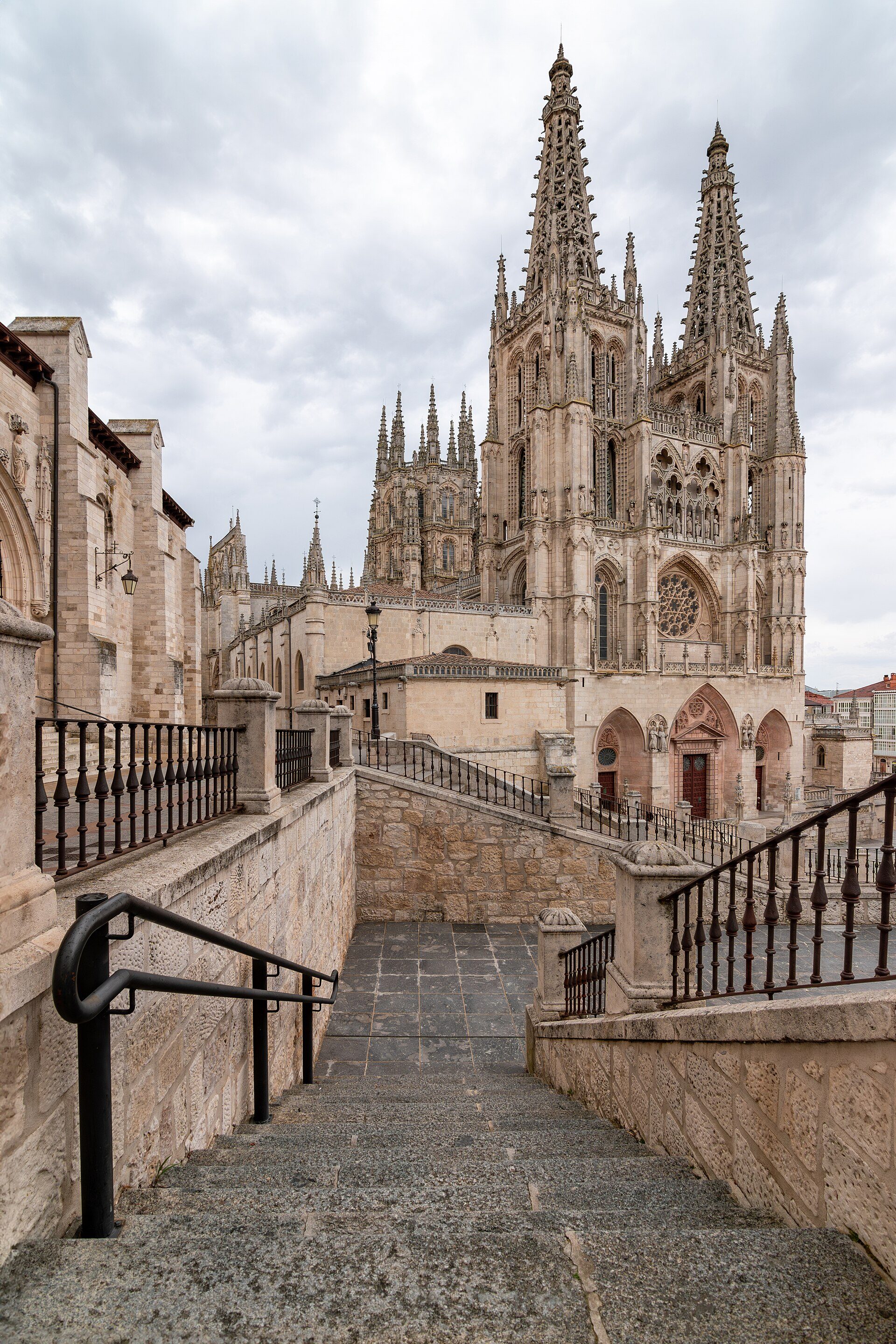 Alt text: Historic cathedral view from stone staircase with ornate railings.