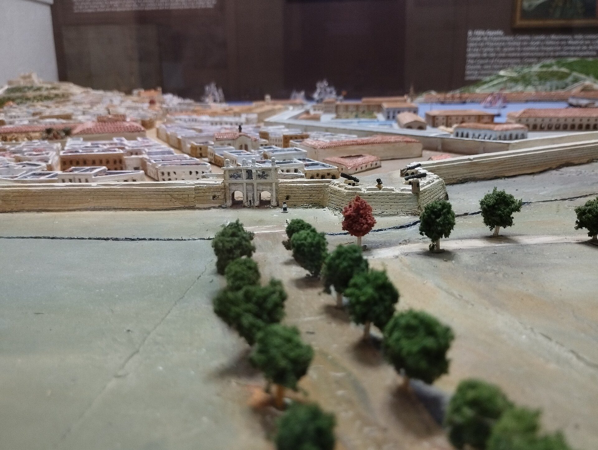 Detailed scale model of a cityscape with buildings, trees, and waterways.