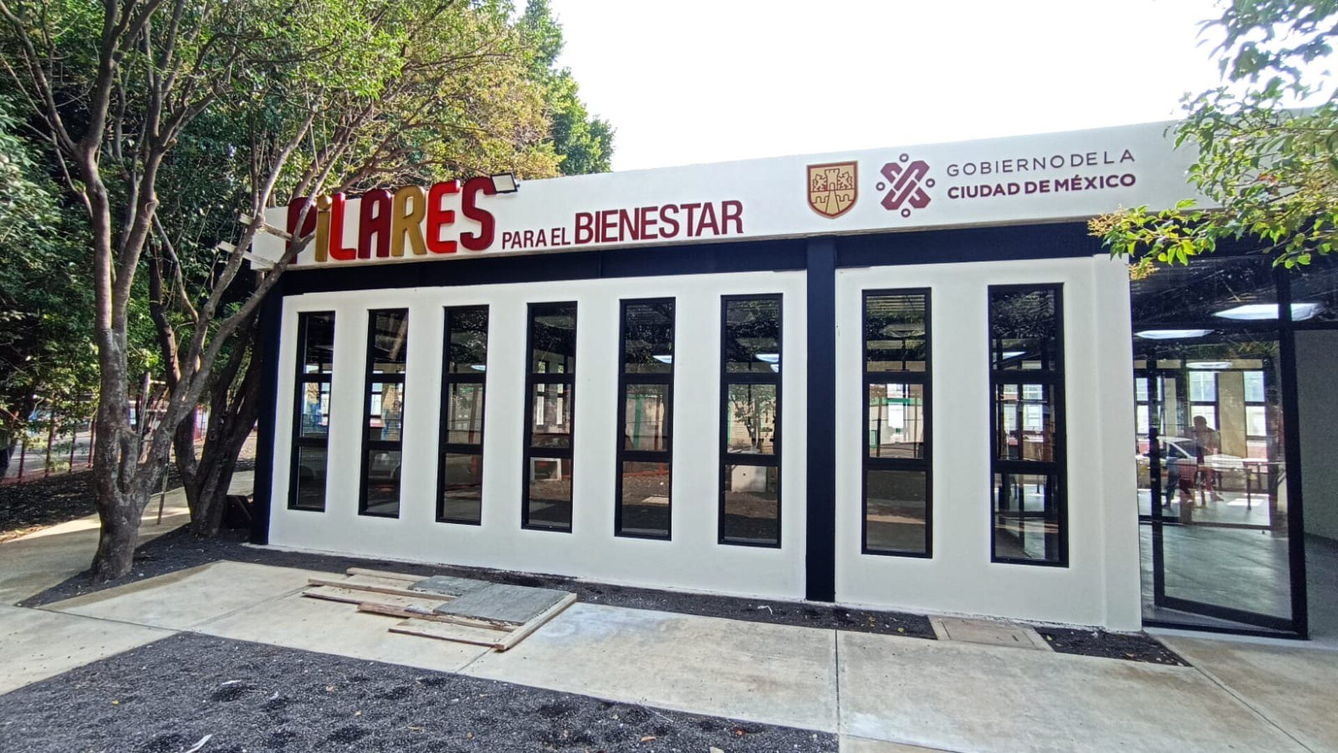 Modern conference room with large windows, natural light, and city view.