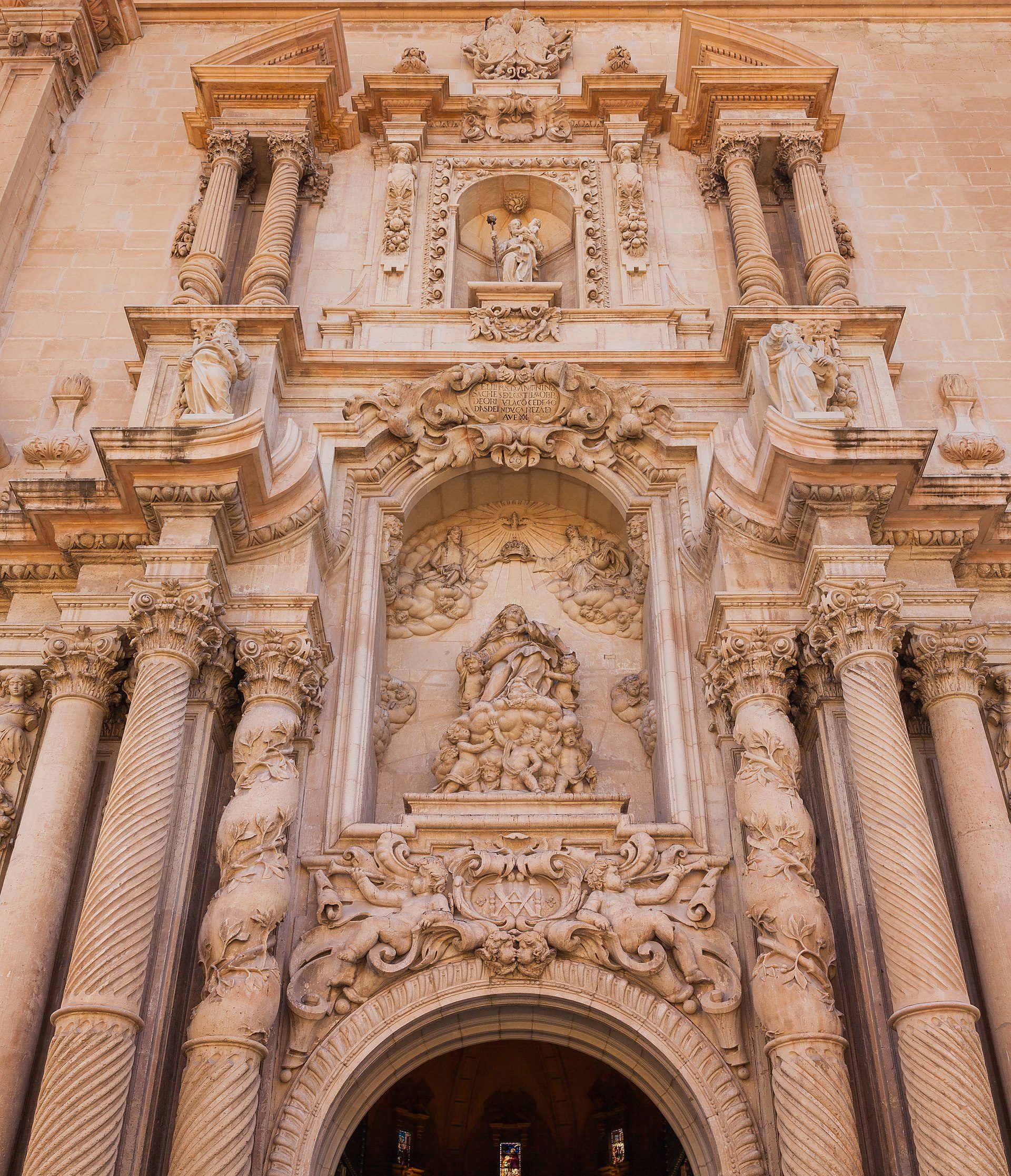 Alt text: Ornate church entrance with detailed carvings and statues.