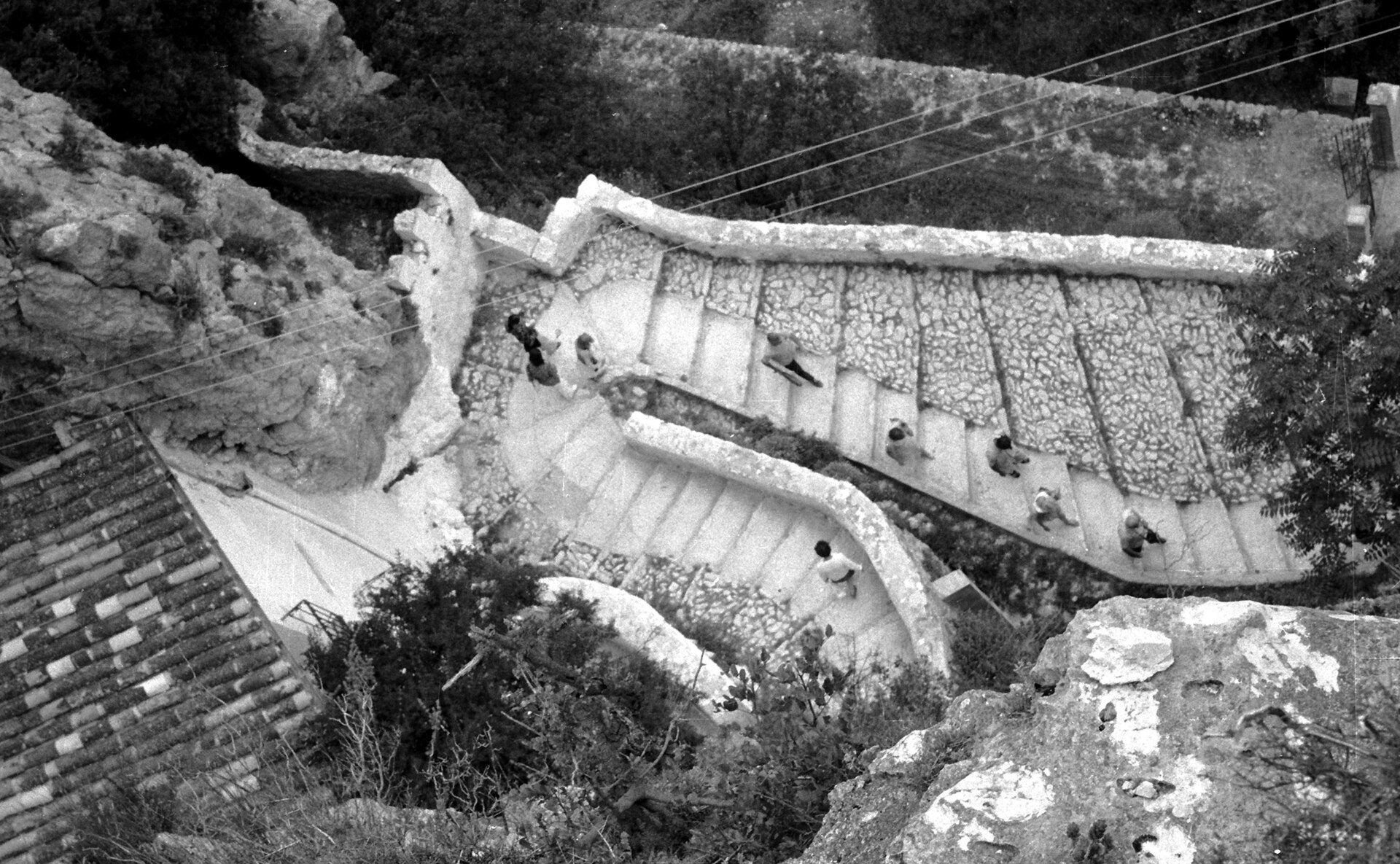 Alt text: Stone terrace with panoramic view, outdoor seating, and natural surroundings.