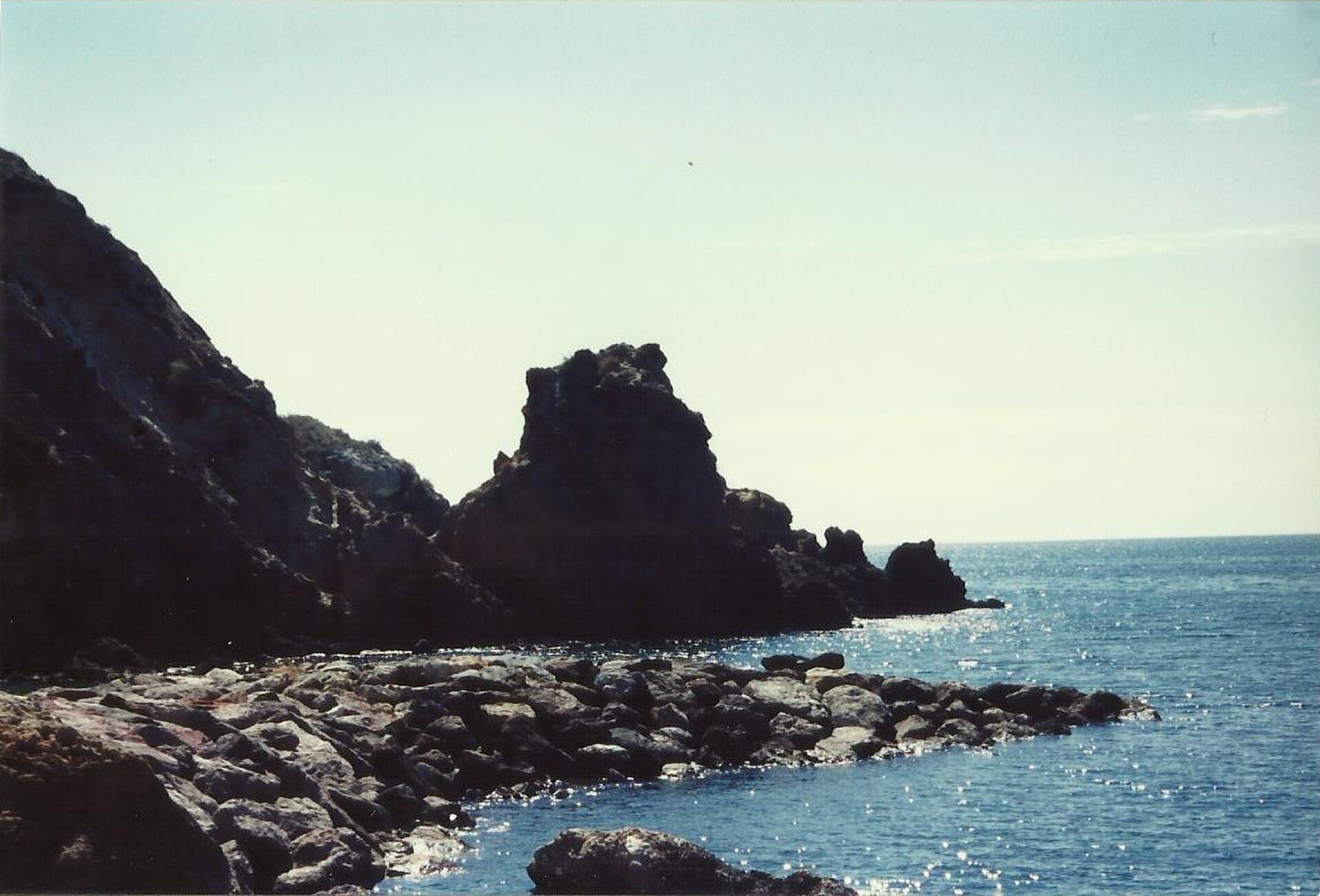Coastal rock formations, ocean view, natural landscape.