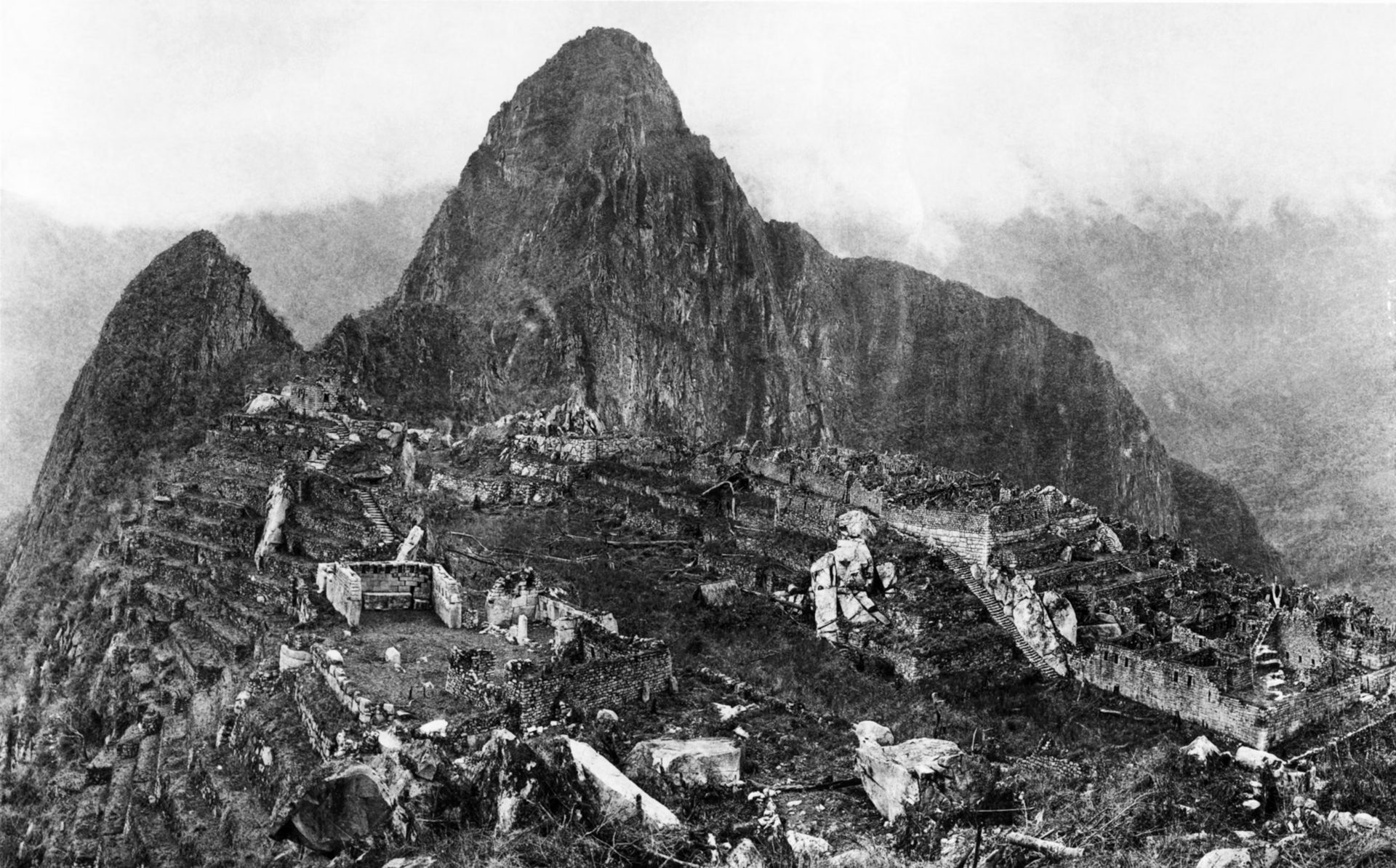Panoramic view of a mountainous landscape with ancient ruins and a prominent peak.