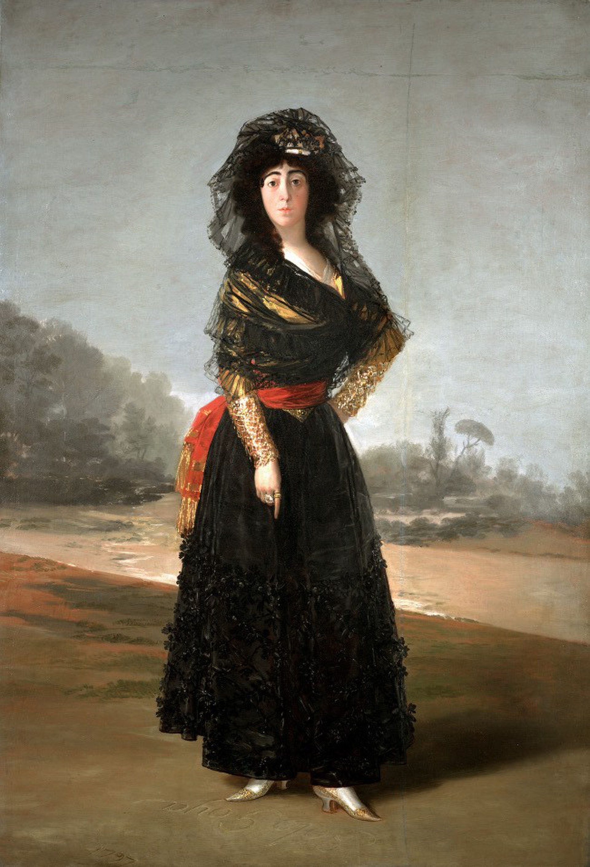 A woman in a black dress with a red sash and lace veil stands in a landscape painting.