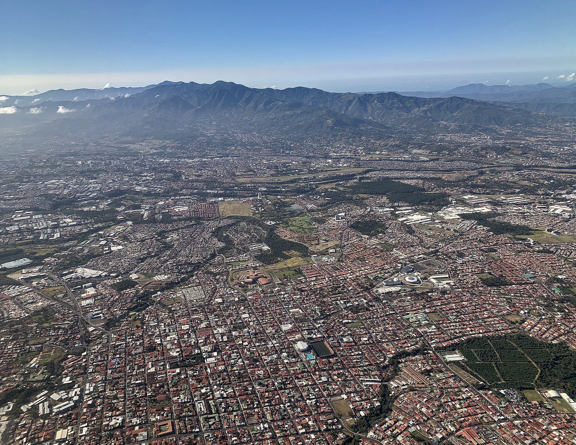 Aerial view of a city with mountains in the background.