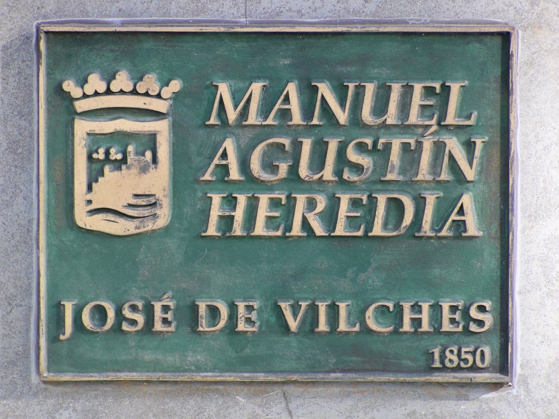 Green plaque with text and emblem, featuring "Manuel Augustin Heredia" and "Jose de Vilches 1850.
