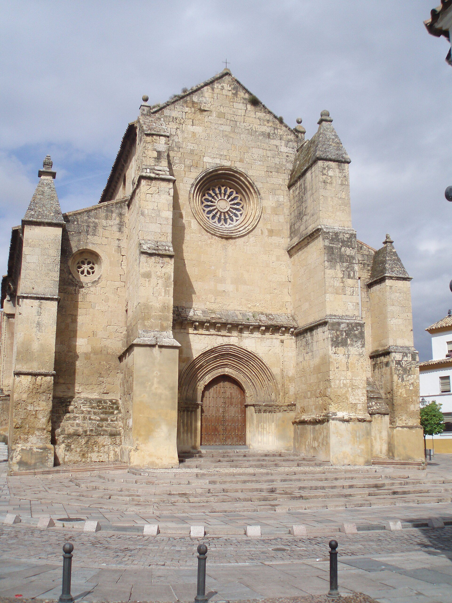 Alt text: Historic stone church with large rose window and arched entrance.