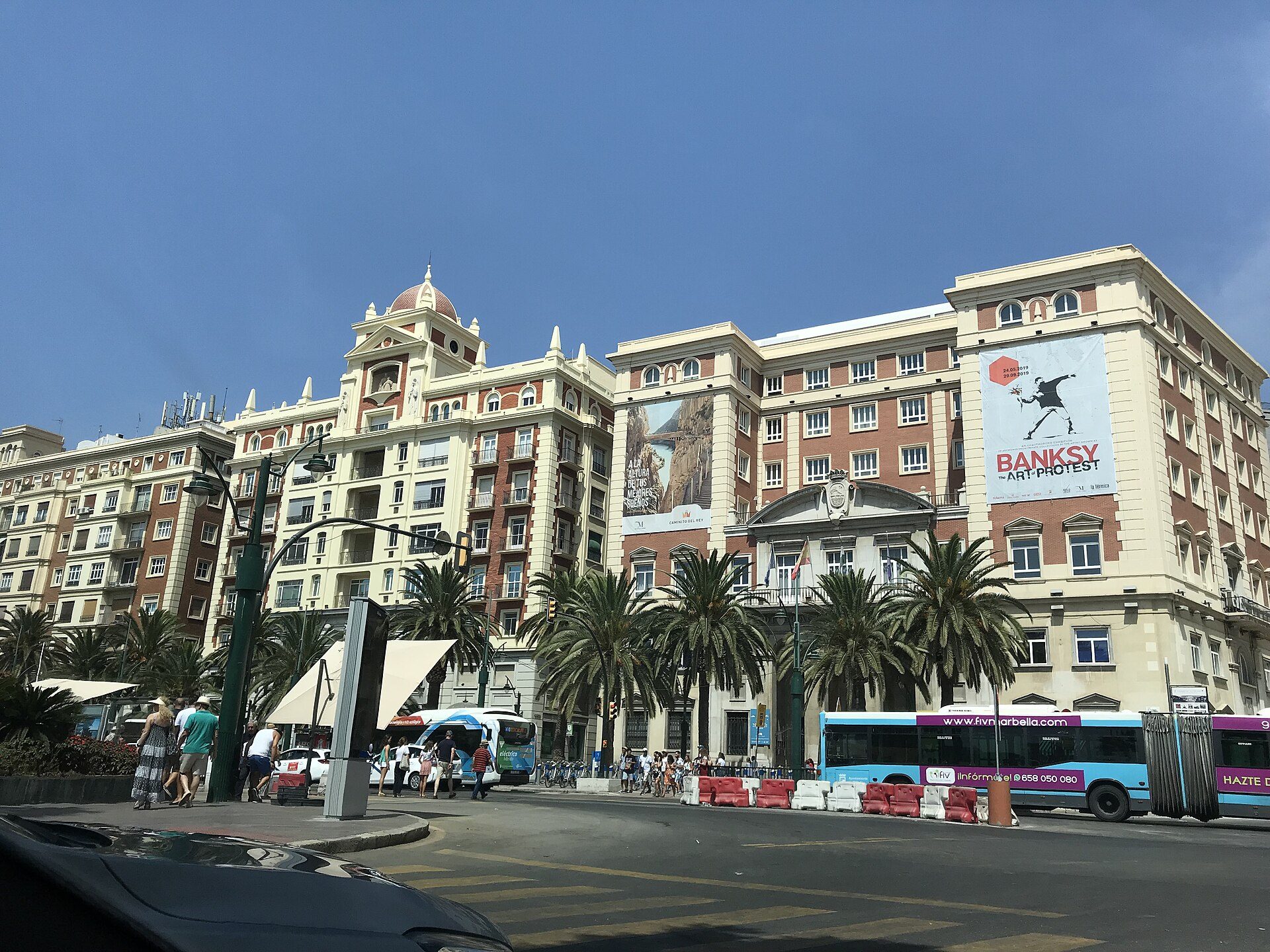 Luxurious hotel room with city view, balcony, modern amenities, and elegant decor.