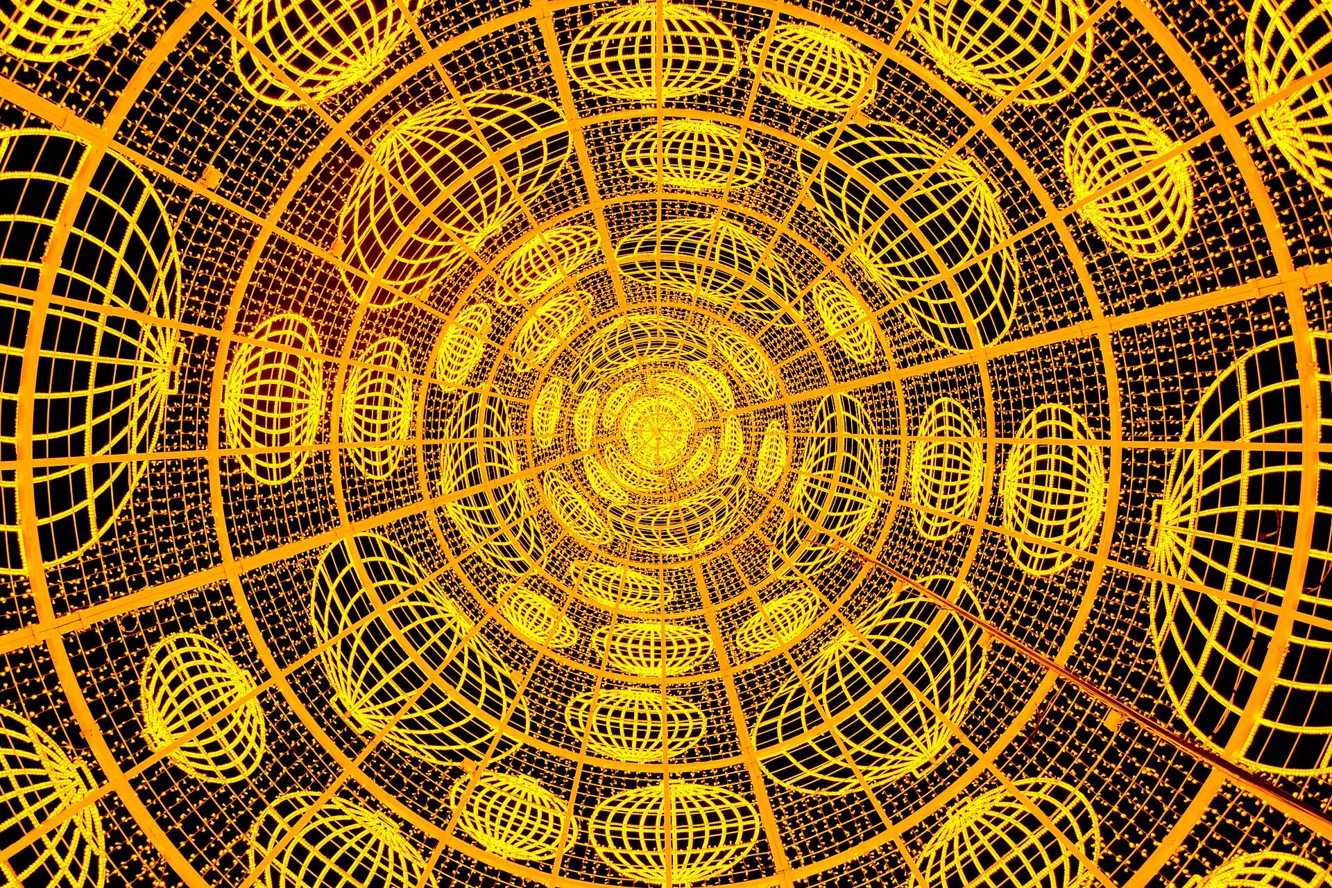 Circular room with a futuristic design, featuring a grid pattern and glowing orbs.