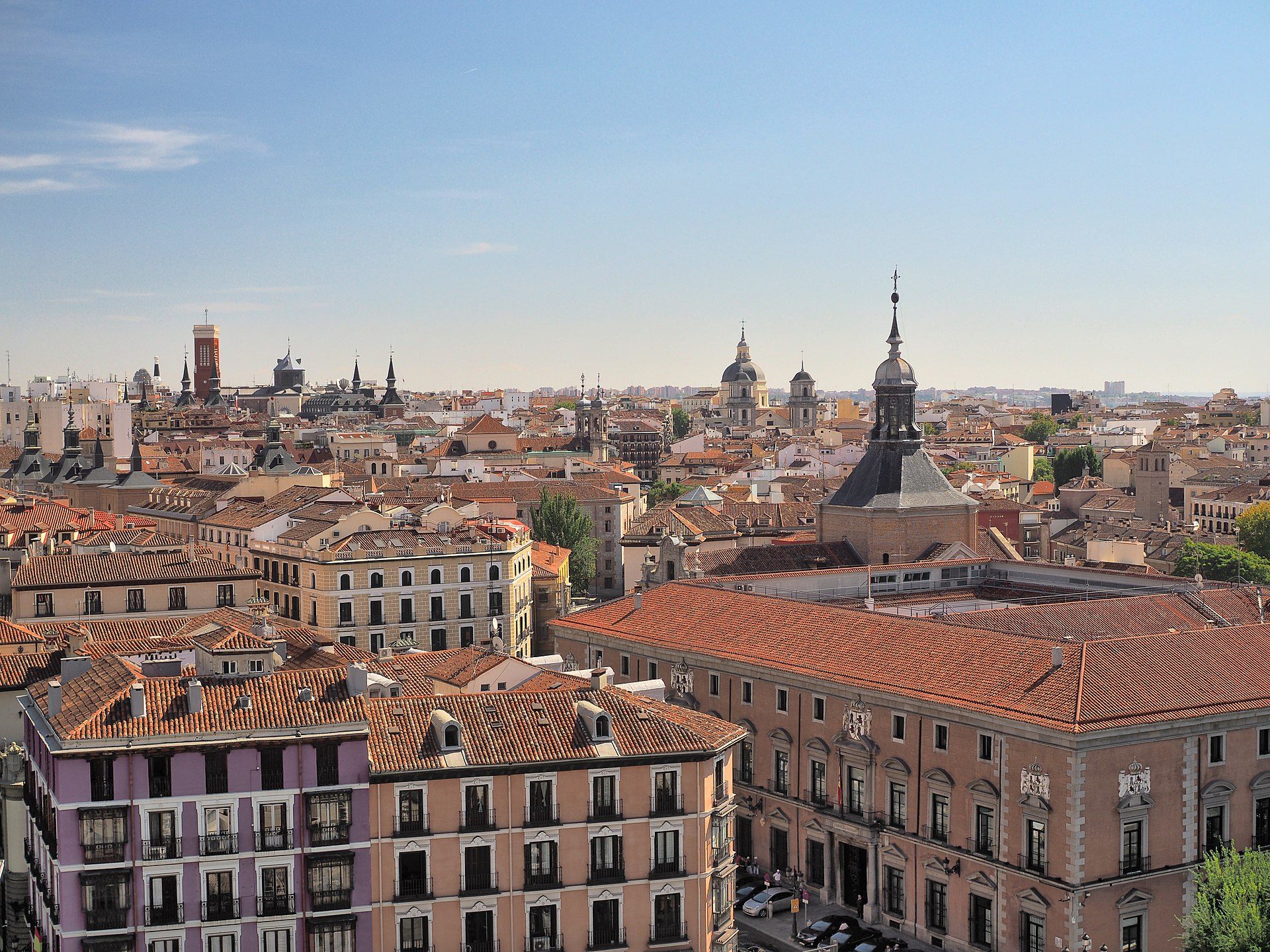 Spacious room with city view, featuring large windows and modern decor.