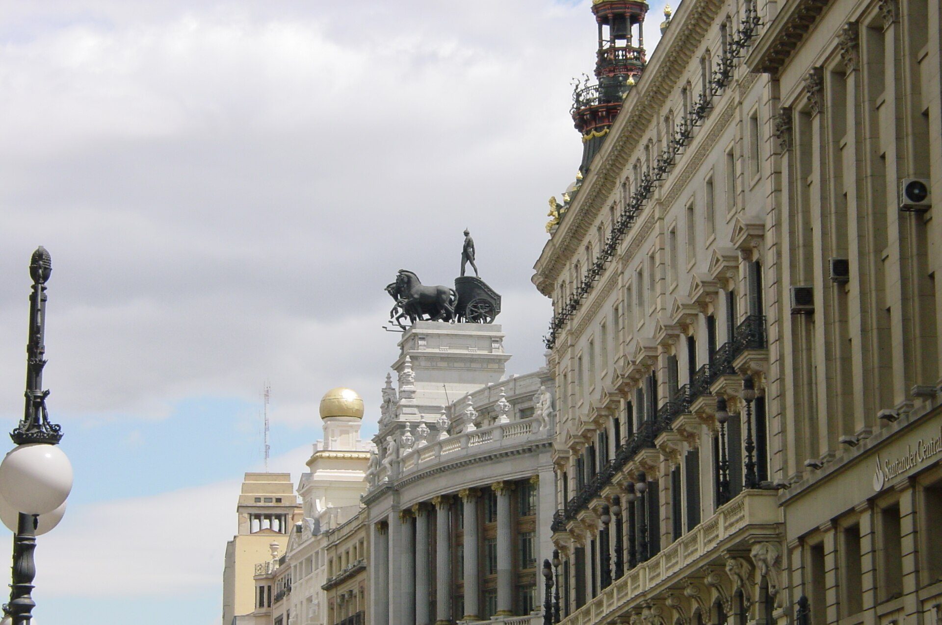 Alt text: Elegant room with cityscape view, featuring ornate architecture and a statue.
