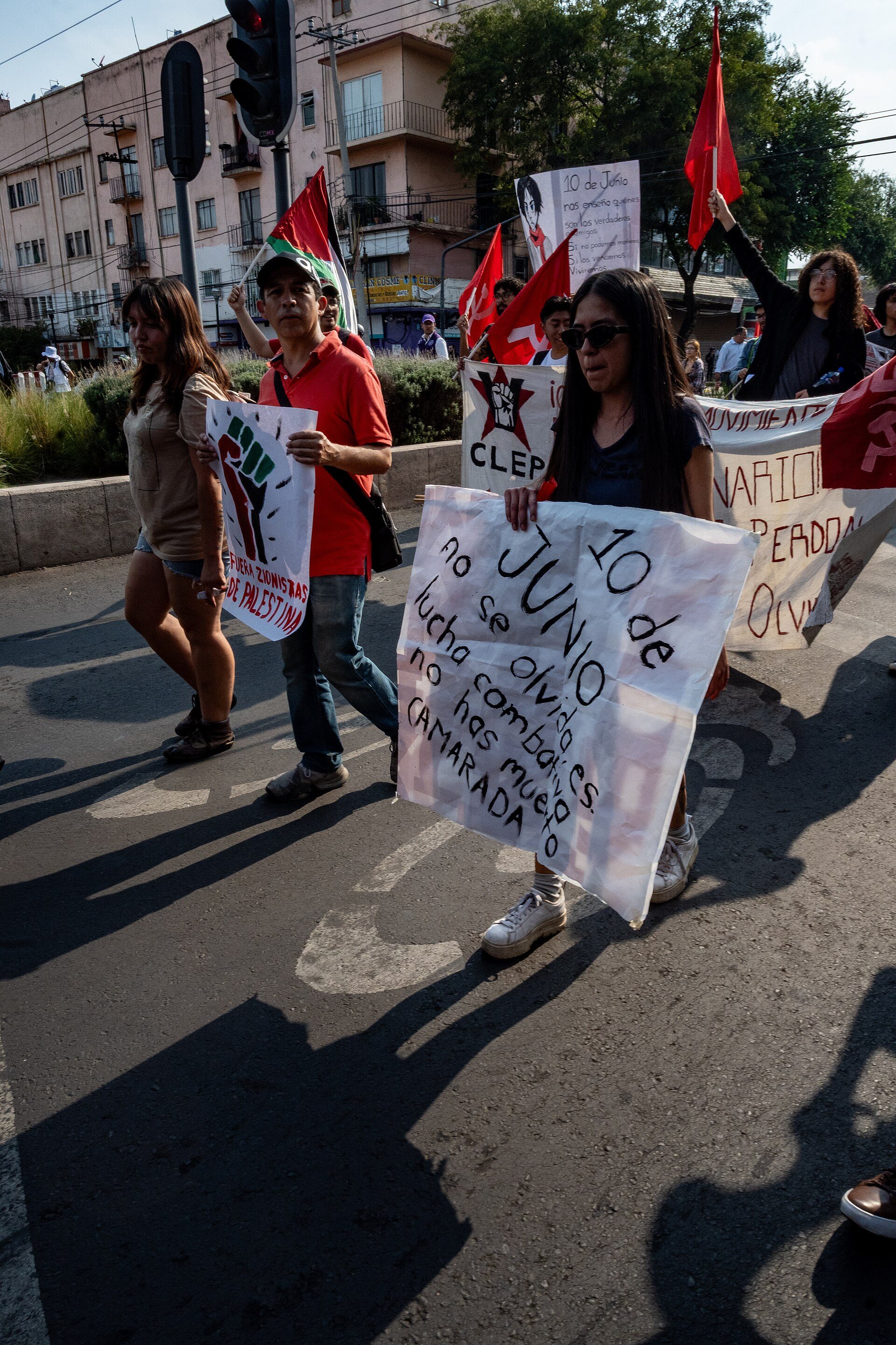 A spacious living room with a cityscape view, featuring large windows and modern decor.