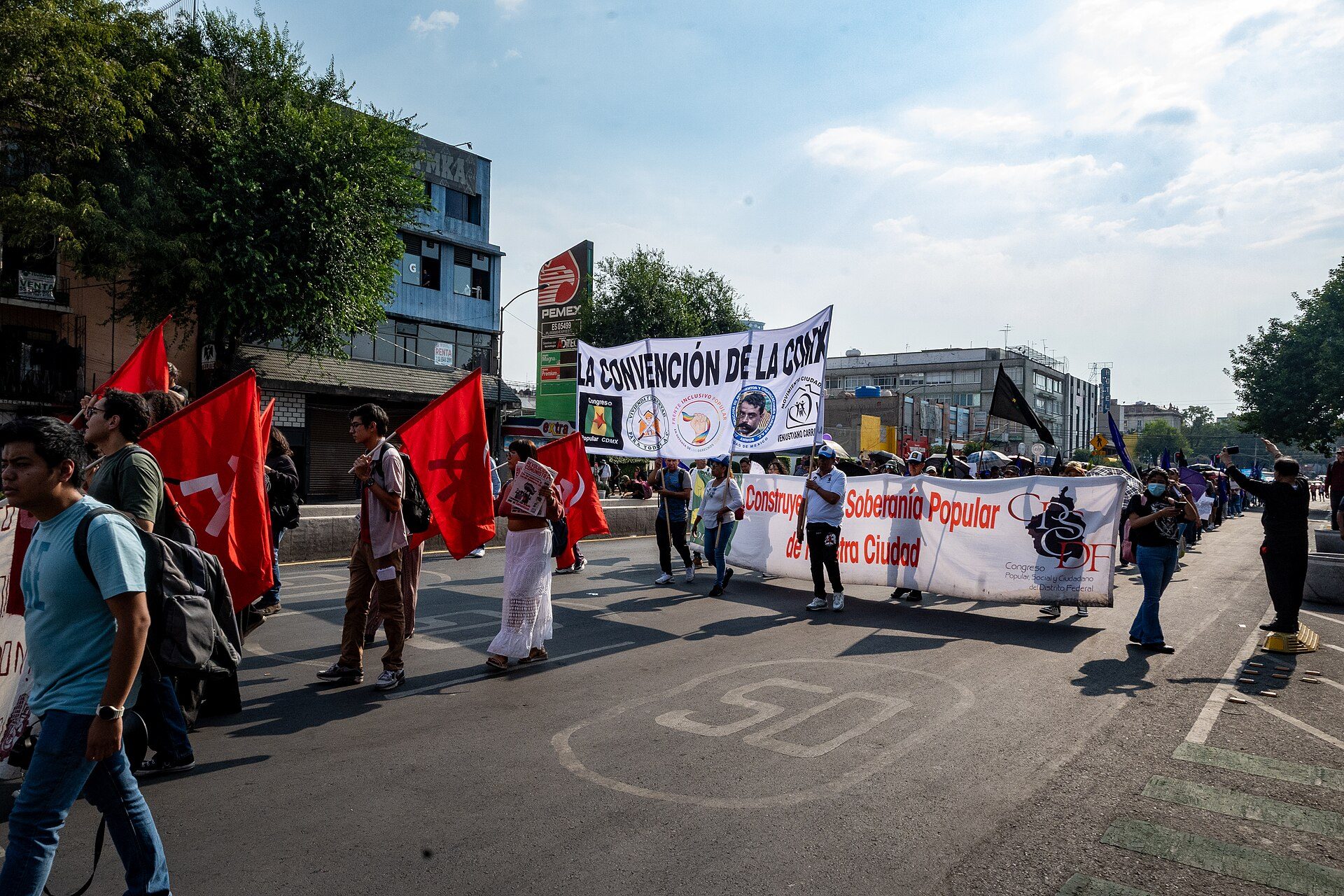 A spacious room with a city view, featuring a balcony and modern furnishings.