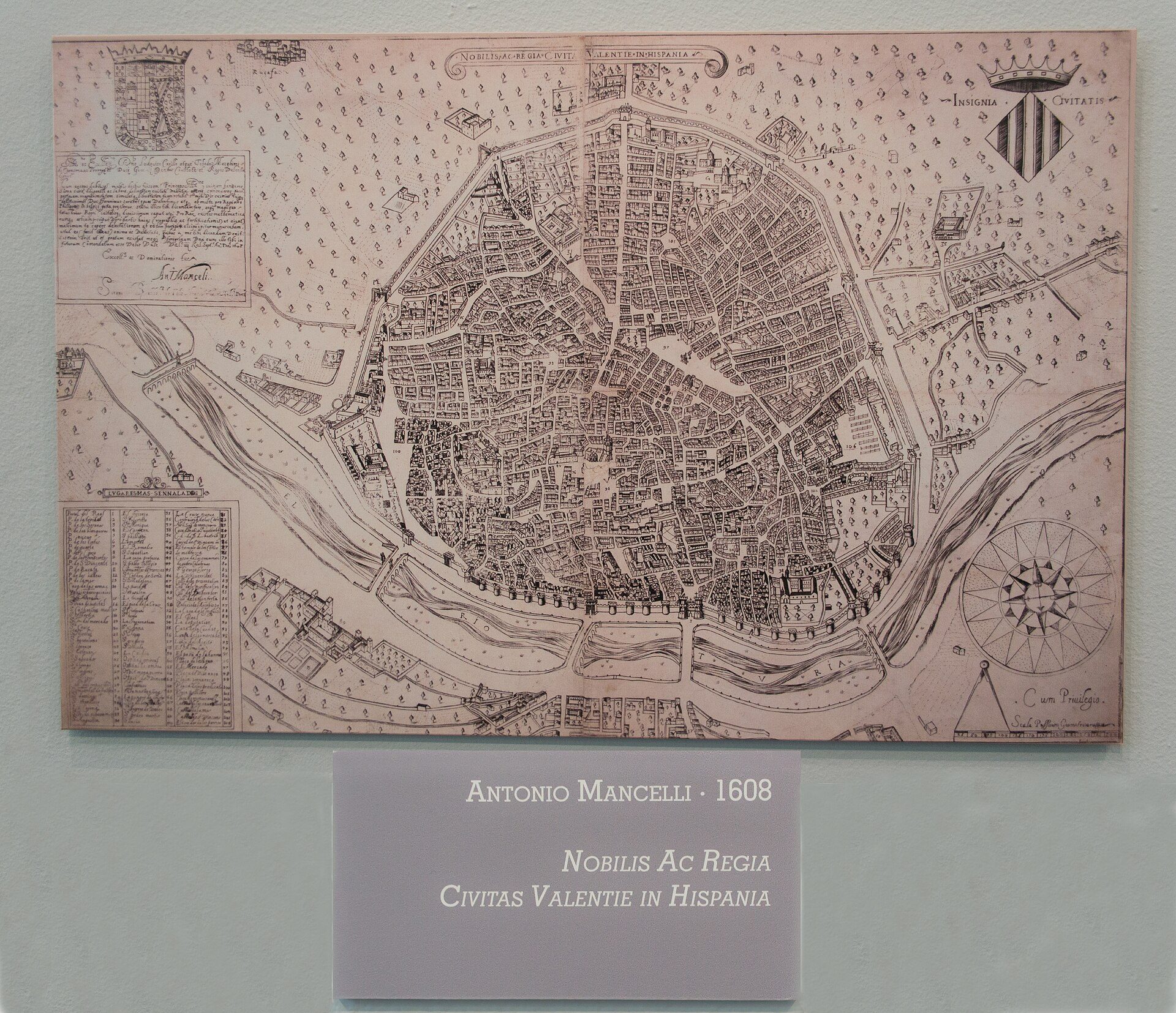 A framed map of a city from 1608, displayed on a wall.