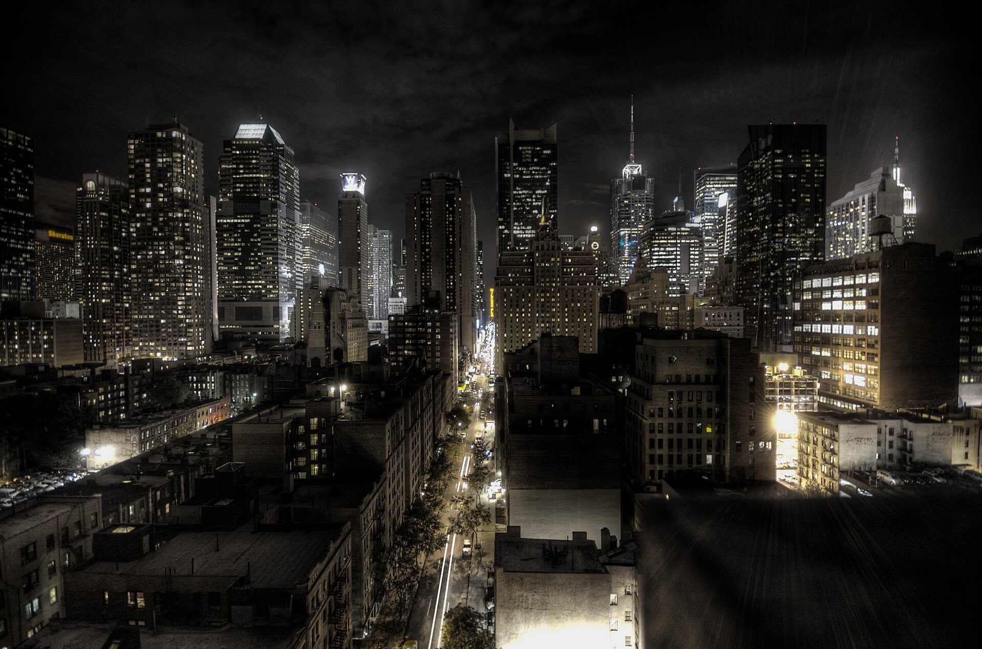 Alt text: Spacious studio with city skyline view, modern amenities, and large windows.