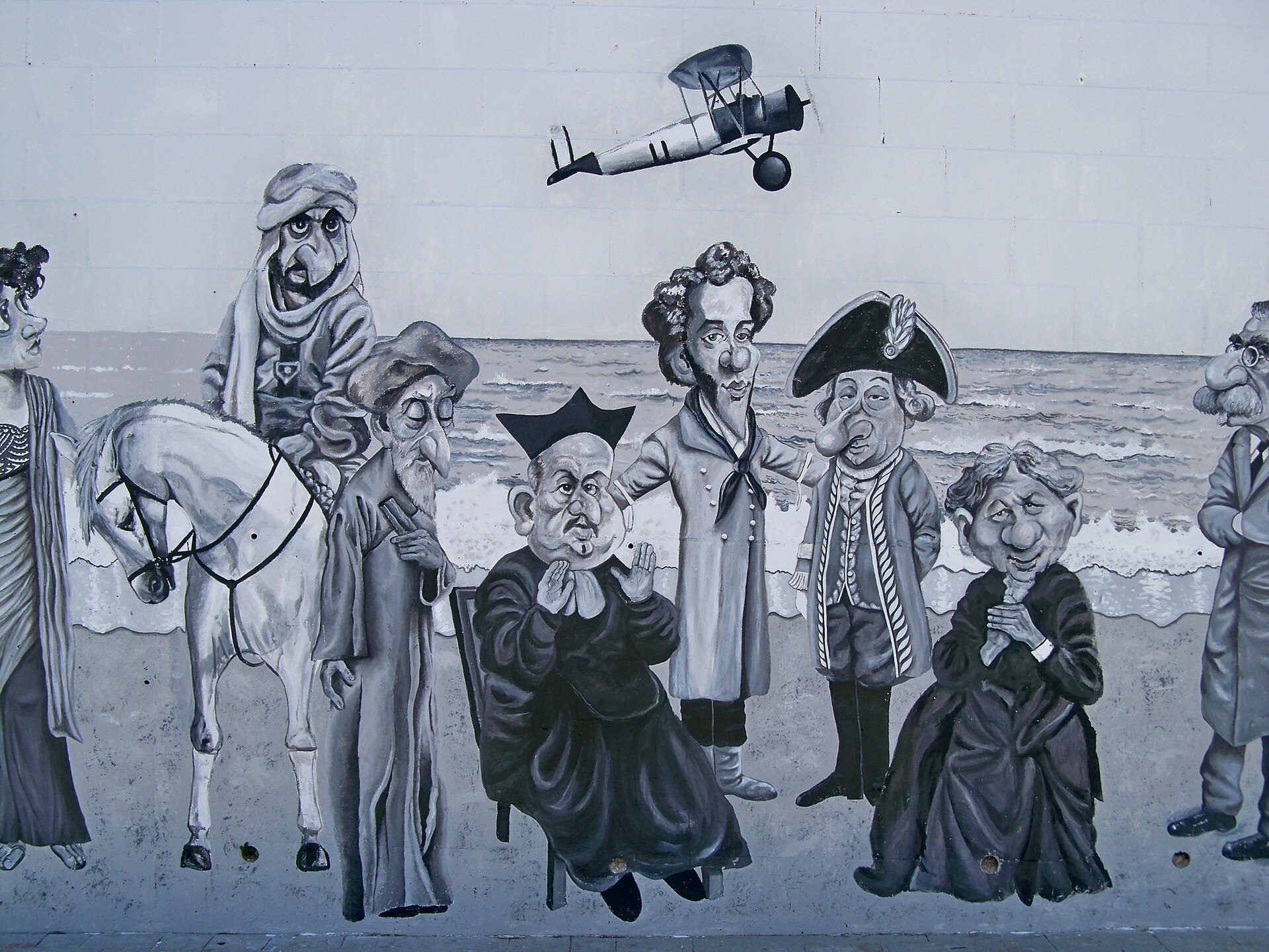 A mural depicting historical figures and a biplane, with a beach view.