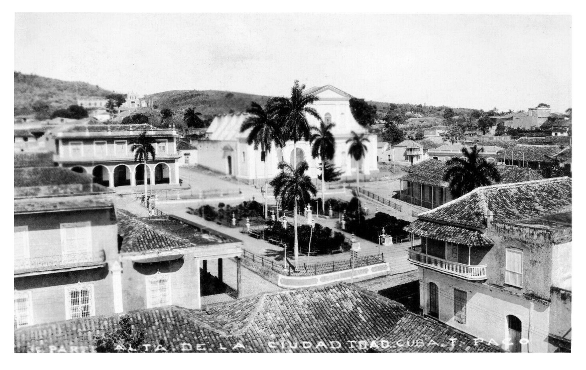 Historic property with courtyard, palm trees, and colonial architecture.