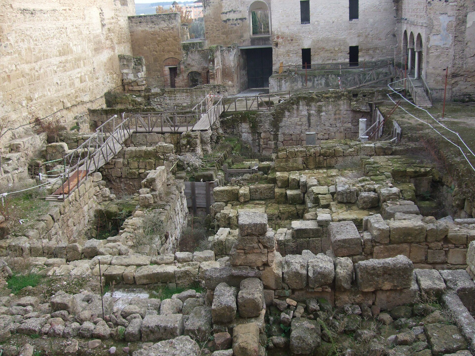 Alt text: Historic stone ruins with arched doorways and overgrown vegetation.