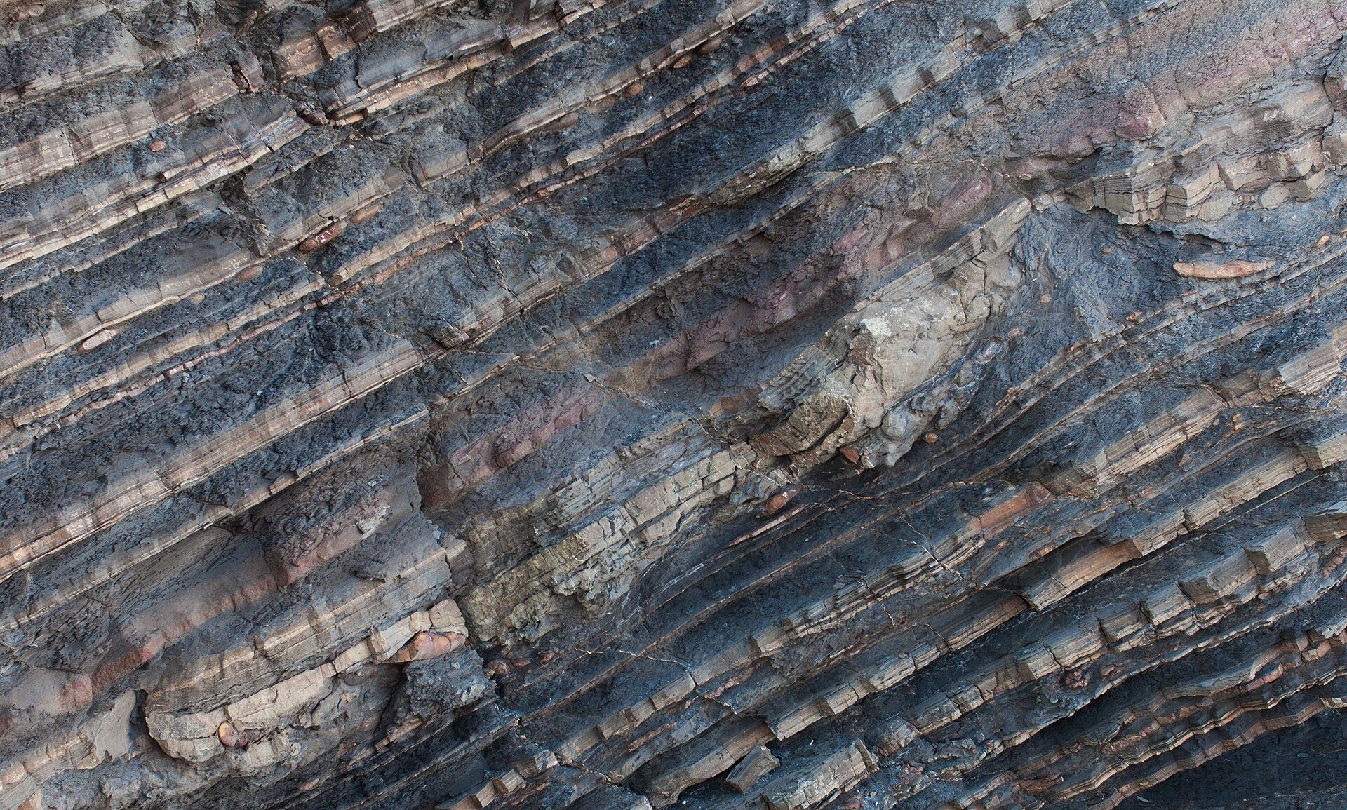 Rocky cliff face with natural striations and textures.
