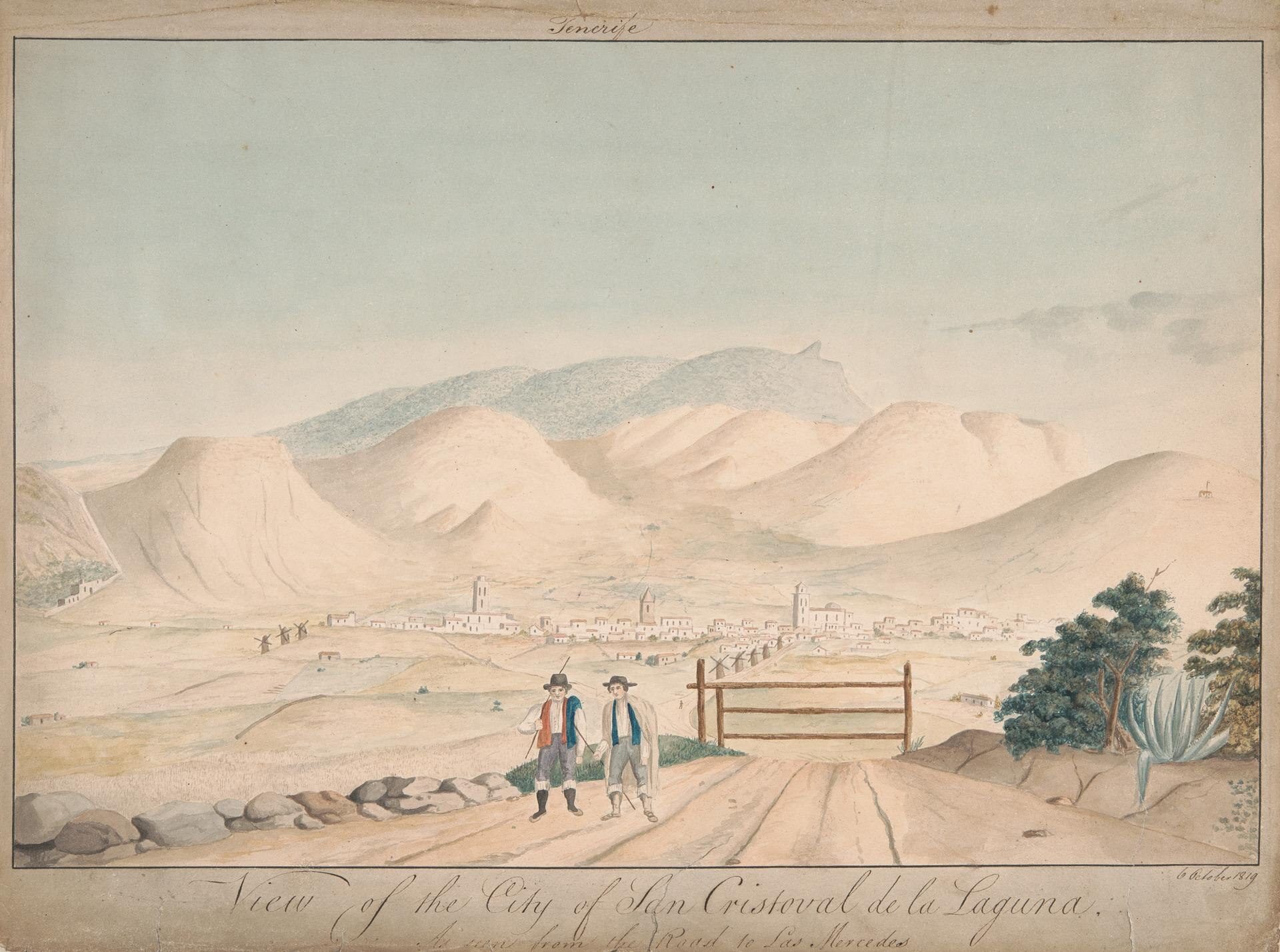 Alt text: Panoramic view of a cityscape with mountains, a town, and two people walking on a path.