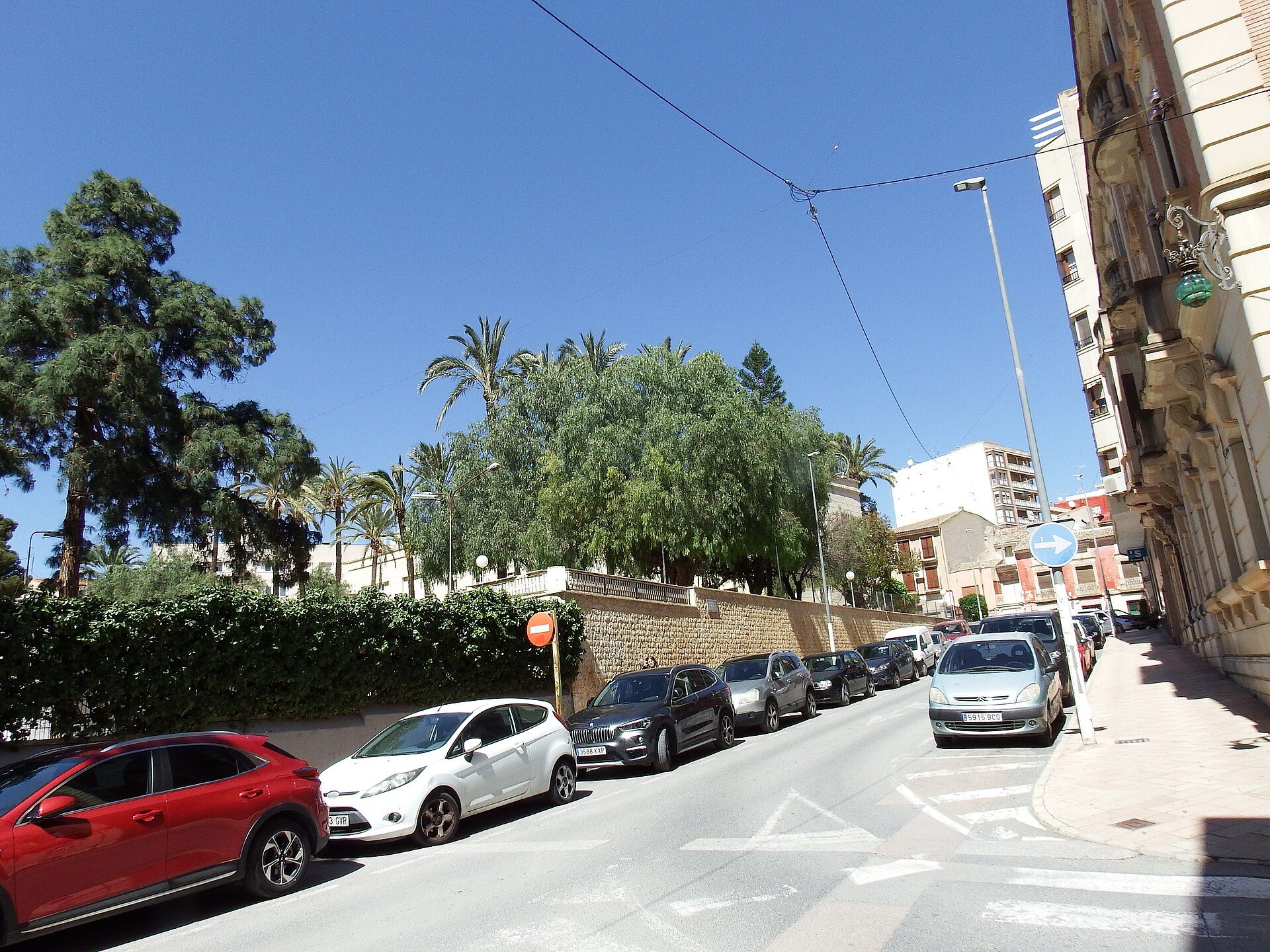 A spacious room with a city street view, featuring large windows and modern decor.