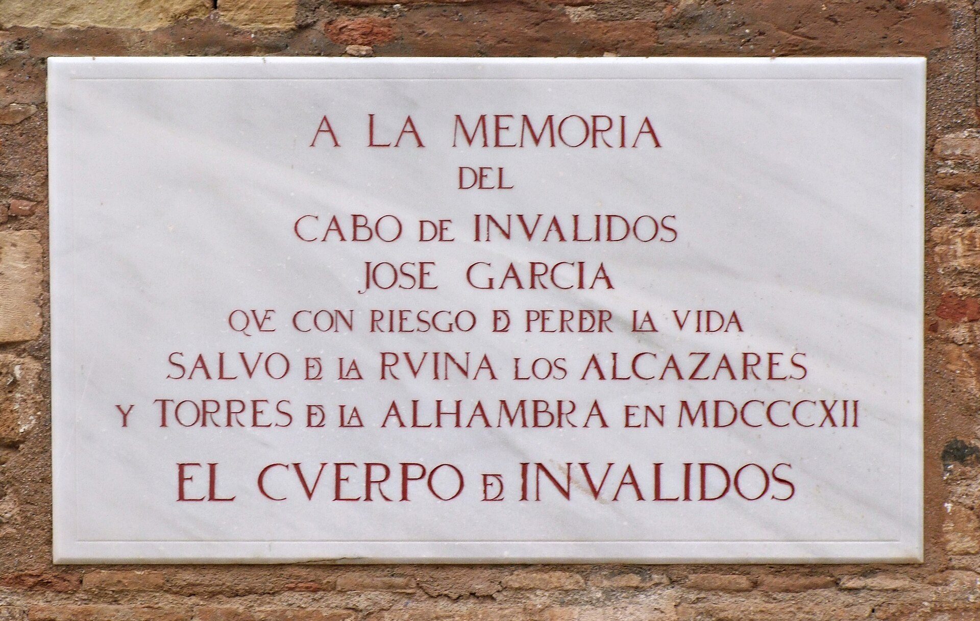 A plaque on a brick wall commemorating the Cabo de Invalidos and its historical significance.
