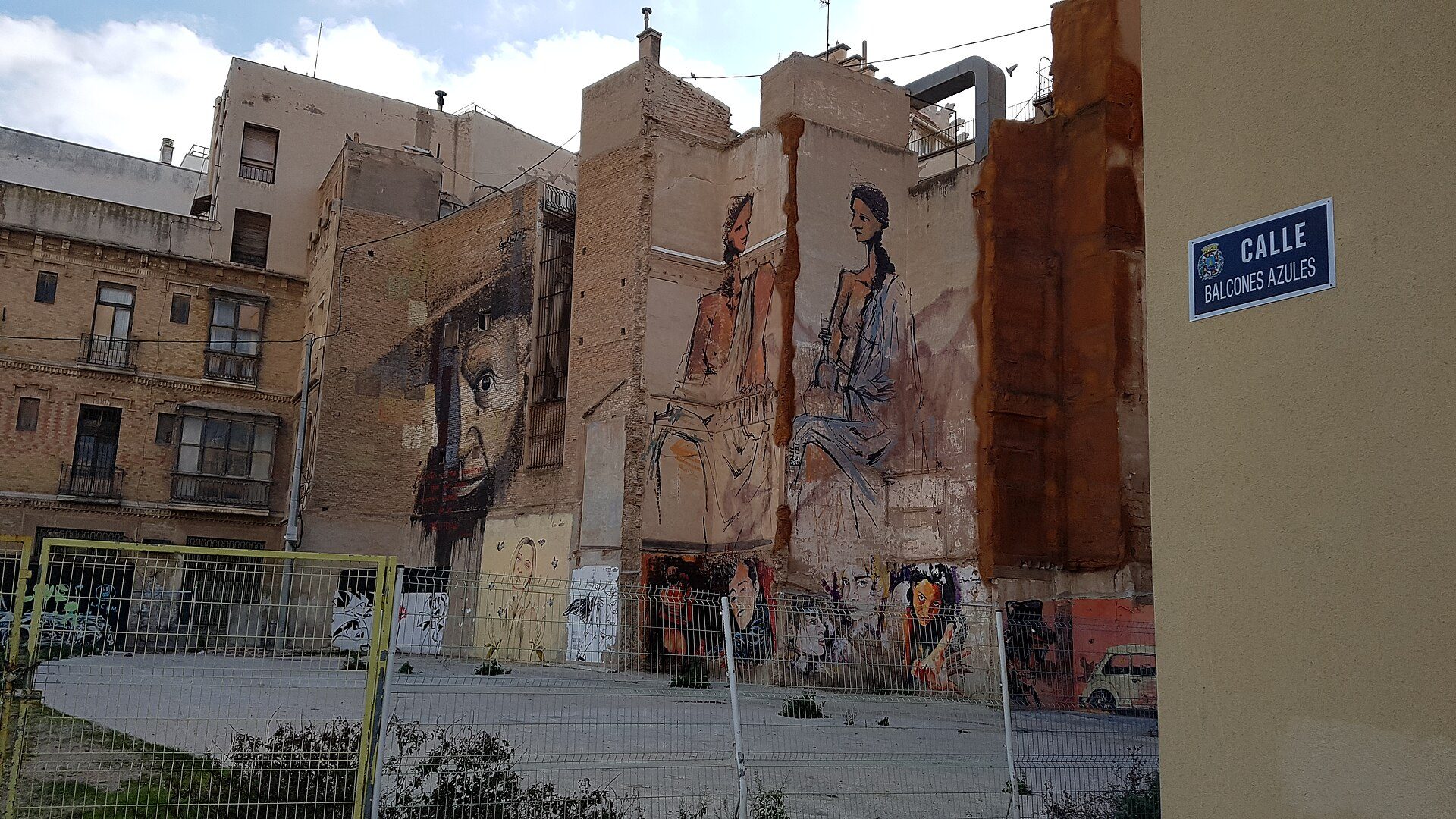 Alt text: Studio apartment with city view, featuring large windows and modern decor.